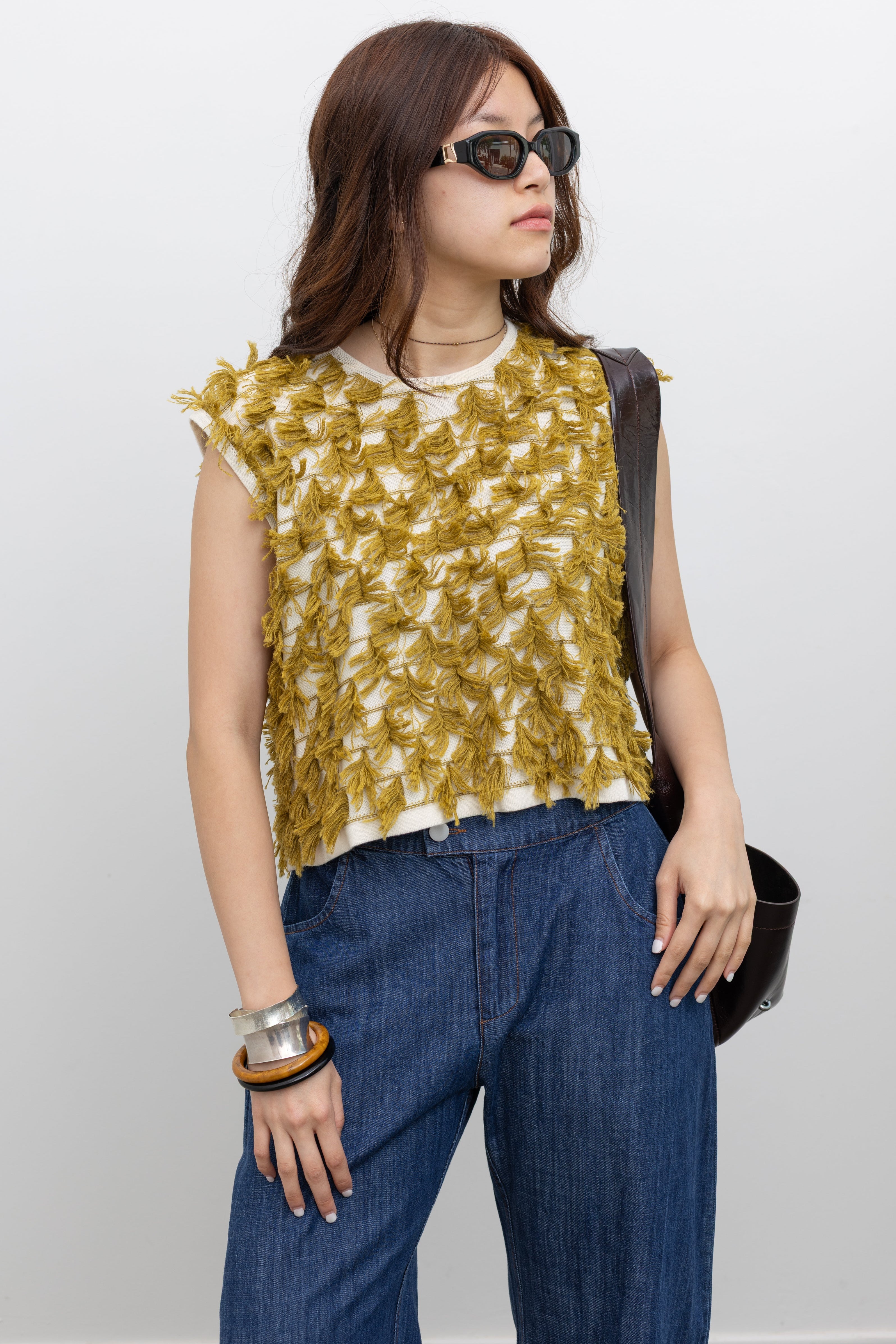 Rachel Comey sleeveless knit top with a boxy silhouette and rows of three-dimensional fringe detailing at Alas Eius.