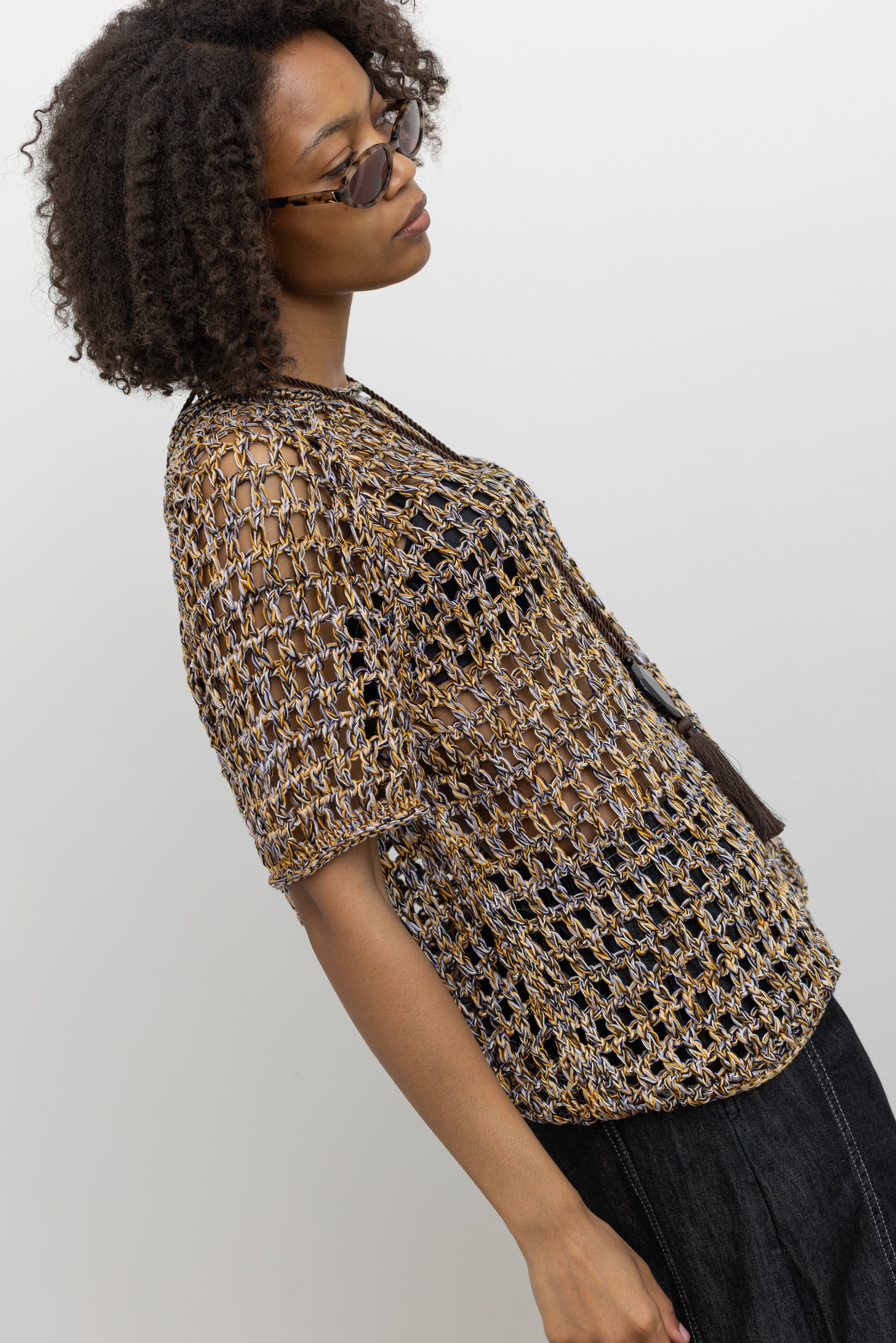 Model wearing Rachel Comey lightweight multicolor open-knit top crafted from soft cotton, featuring a classic crew neck and relaxed silhouette at Alas Eius. 