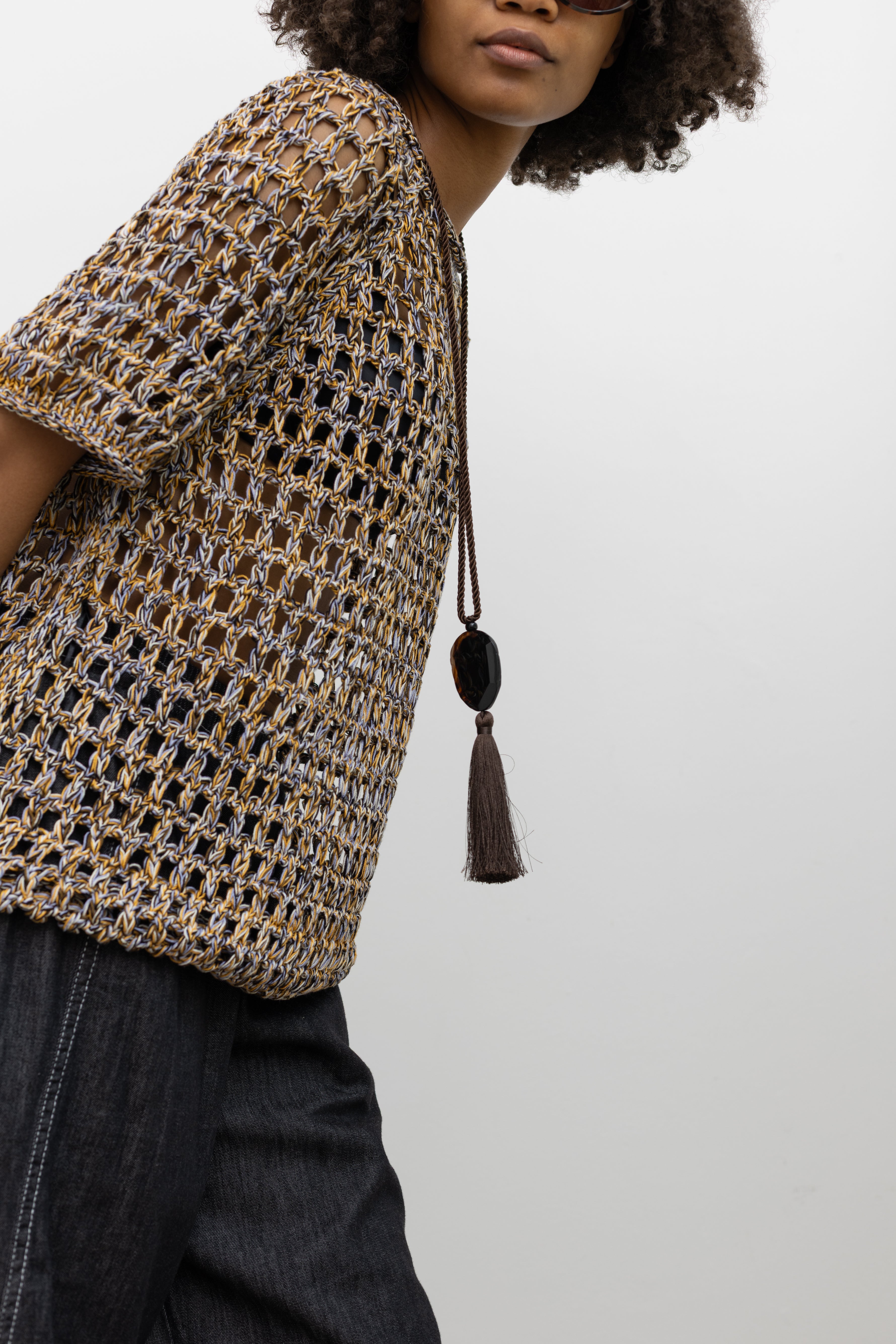 Model wearing Rachel Comey breezy open-knit sweater in multicolored Pima mercerized cotton with rolled hems and a laid-back fit at Alas Eius