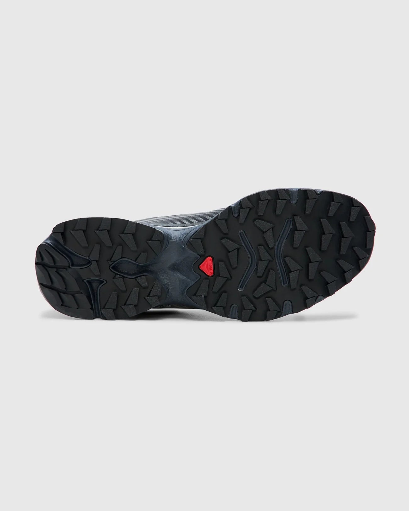 Outsole of the Salomon XT-4 OG Black and Ebony Sneakers featuring quicklace bungy laces and in a sleek and modern black with primary color detail on the tongue suited to contemporary urban wear at an Alas Eius store. 