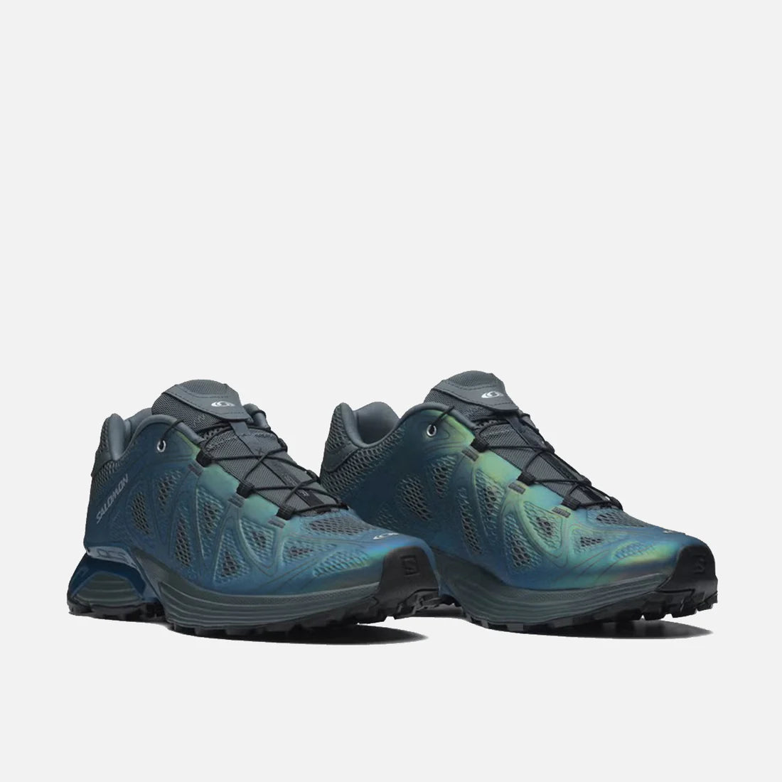 3/4 view of a pair of modern and elevated Salomon XT-Whisper Void Sneakers in a iridescent Dark Slate and Gibraltar Sea colorway featuring quickLACE a minimalistic and strong bungy lace for one-pull tightening and easy-on, easy-off on a white shelf at Alas Eius.