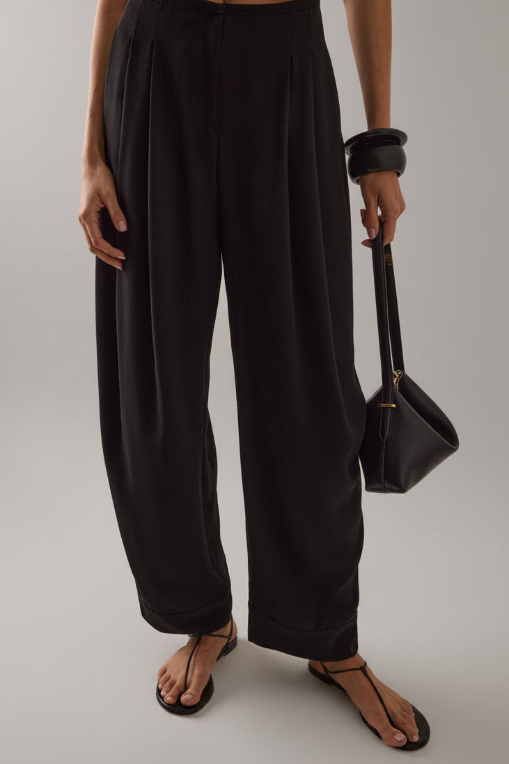 Sloan Pleated Crepe Black Barrel Trouser with sculptural curved-leg silhouette at Alas Eius