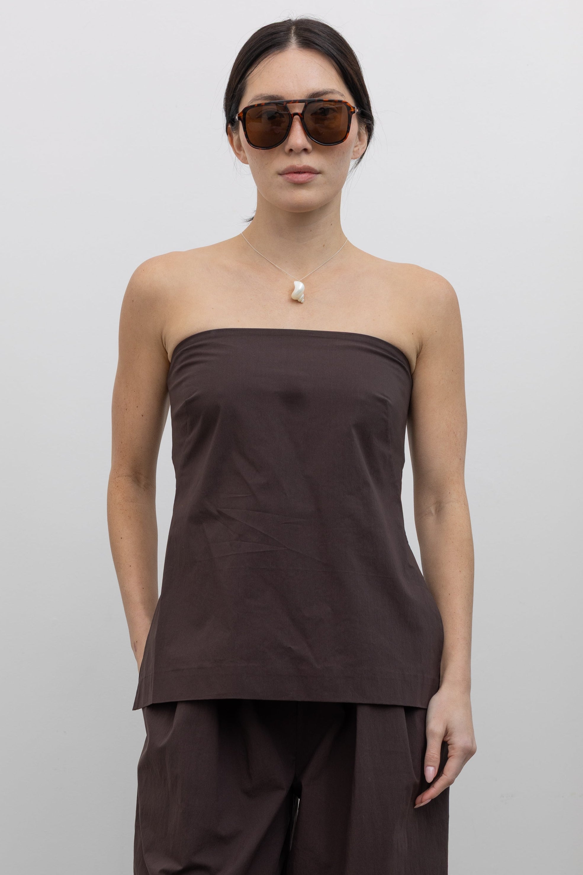 Woman wearing spring fashion in a St. Agni Bark Brown Strapless Rouleau Back Tie Top at Alas Eius.