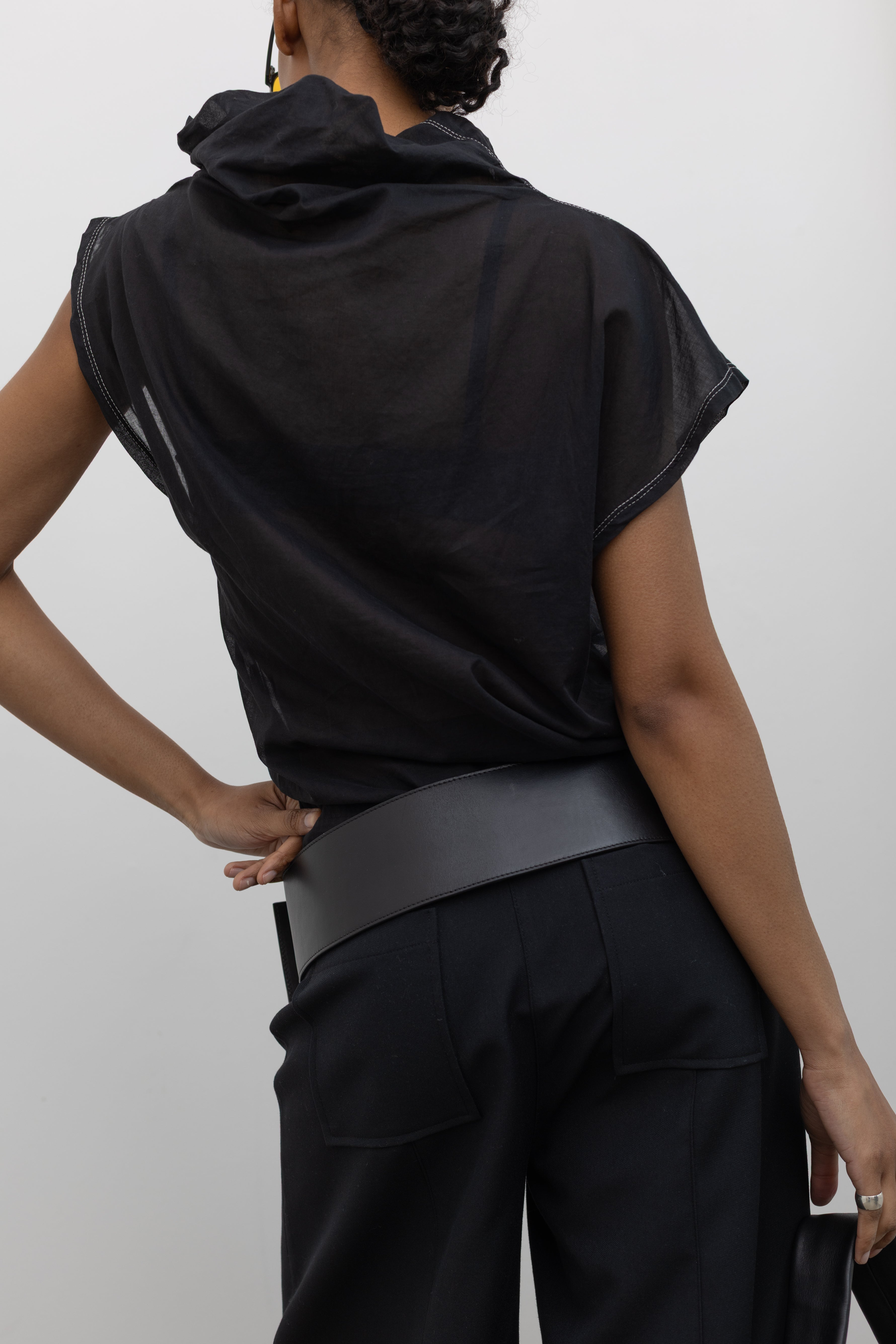 Back view of a Woman wearing a sleek and sophisticated St. Agni Black Leather Wide Classic Belt with a brushed silver rectangular buckle at Alas Eius.