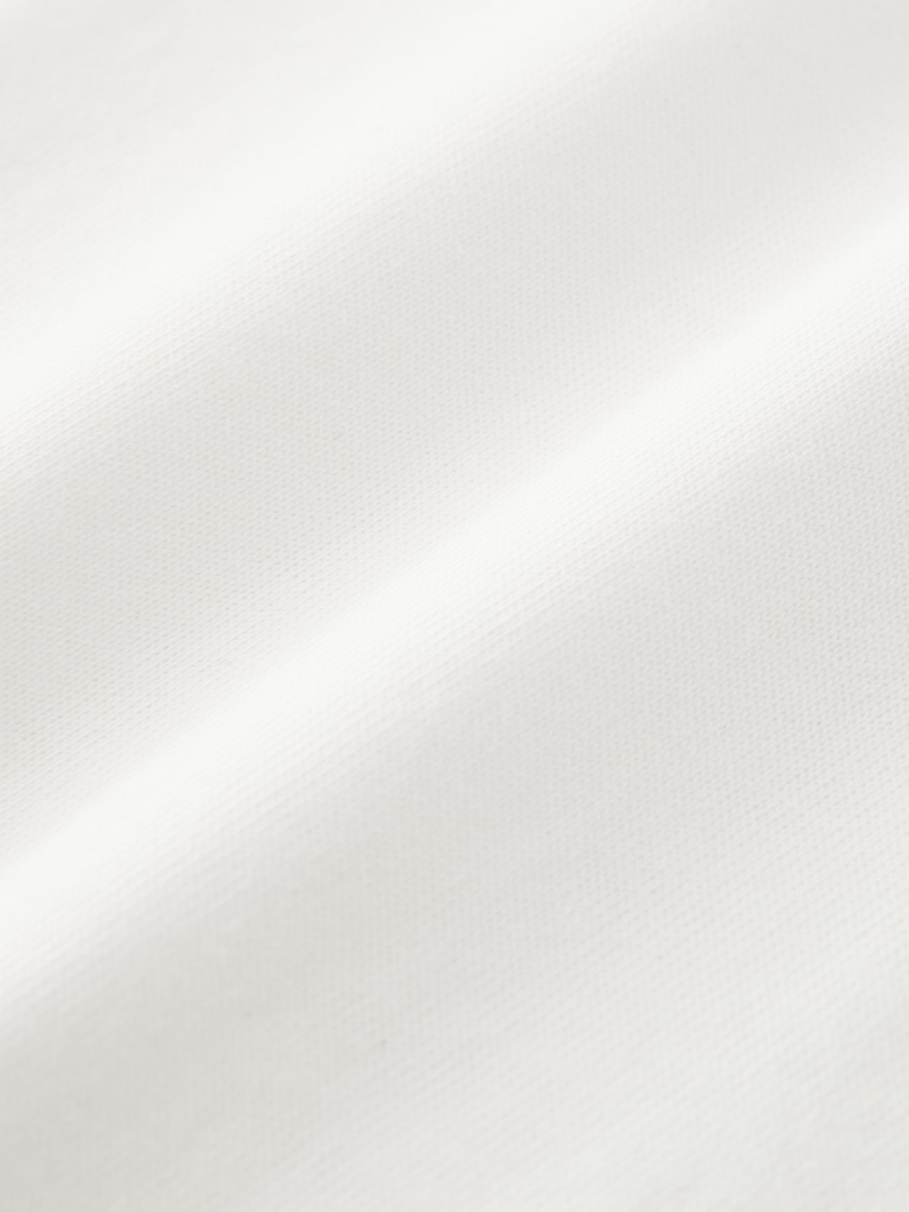 Close-up view of the fabric from the Studio Nicholson Off White Marine T-shirt at Alas Eius.
