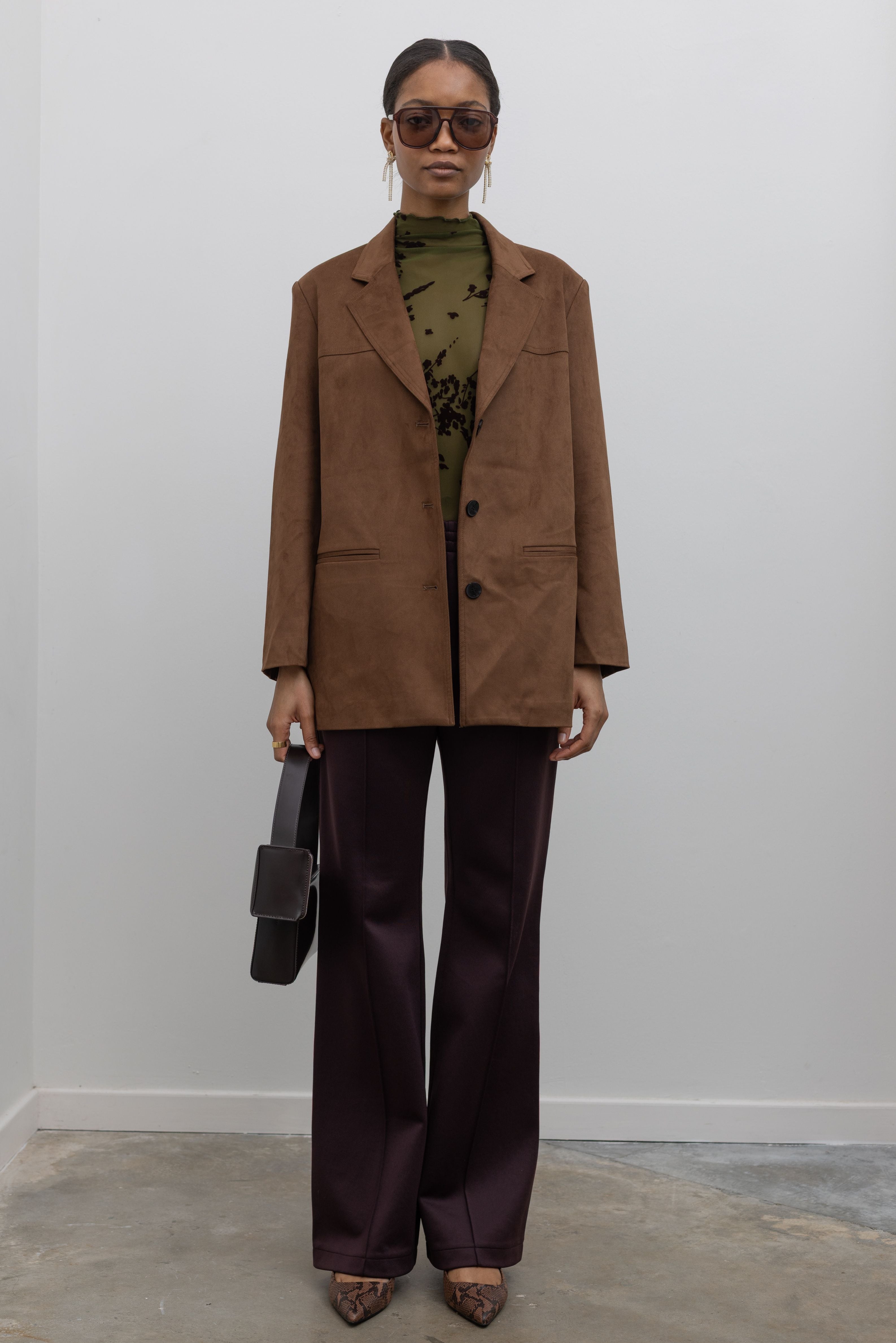 Tibi Scottie brown active knit jogger at alas eius styled with a tan suede blazer and mesh turtleneck
