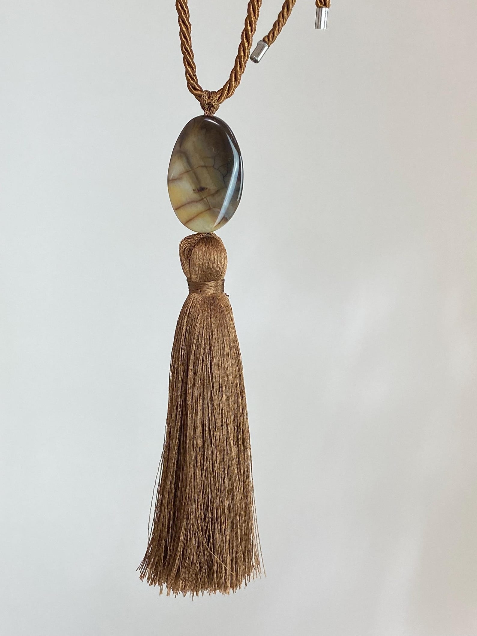 Brown gemstone silk tassel pendant necklace with silk adjustable chord at Alas Eius. Made in Europe. 
