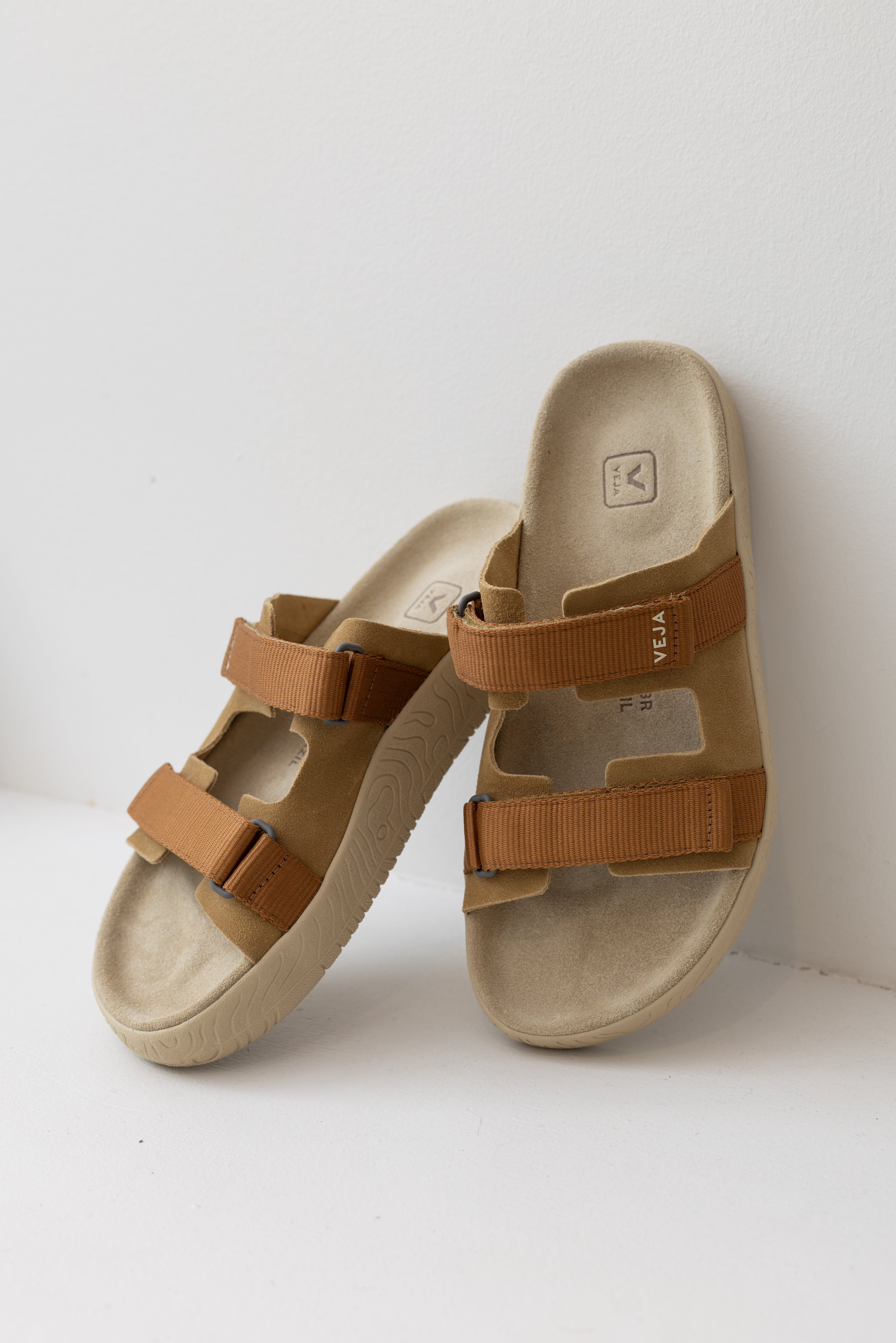Veja Arpoador slide sandal featuring cognac suede double straps and tan adjustable straps set on a beige footbed and lightweight off white platform sole at Alas Eius.