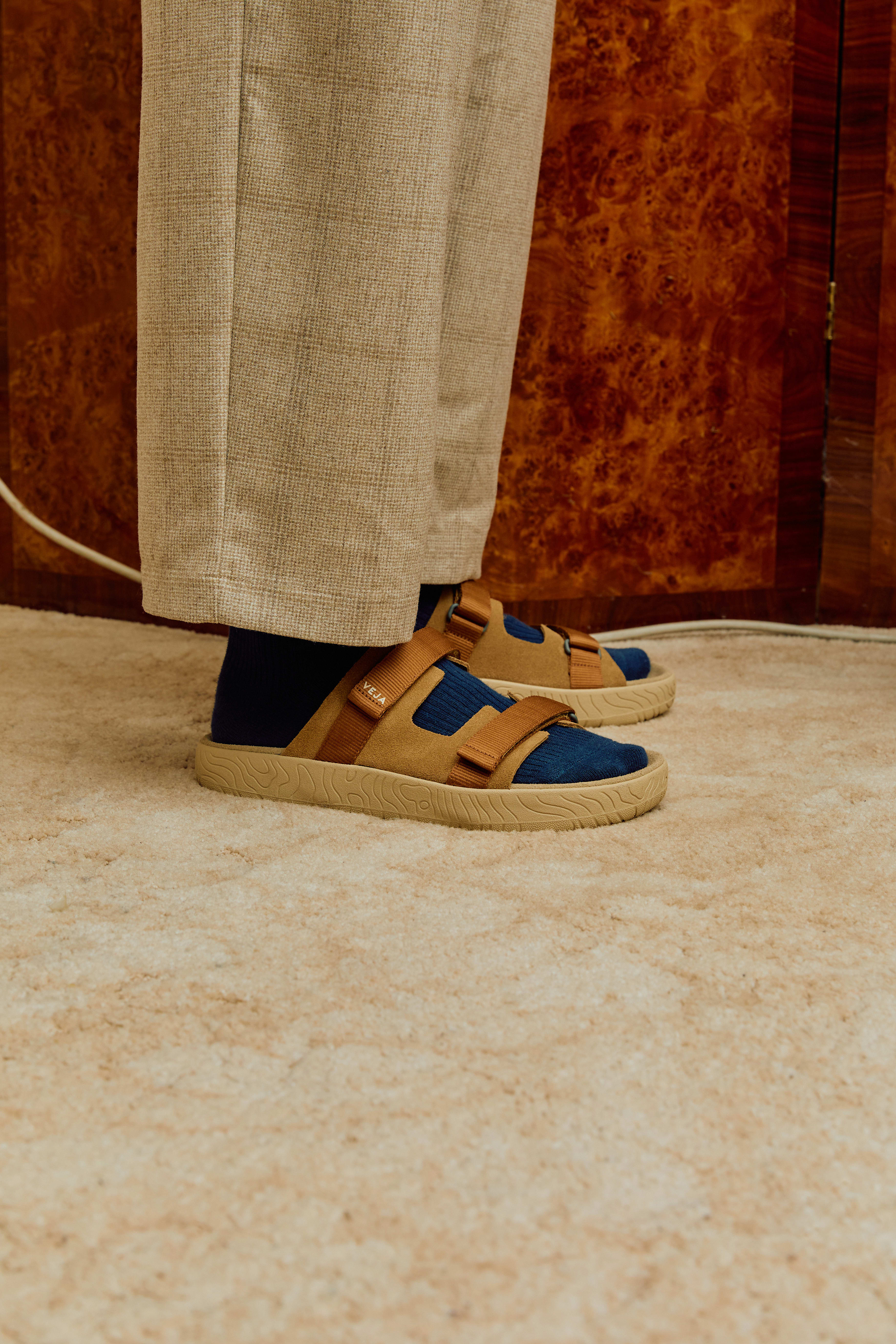 Veja Arpoador slide sandal featuring cognac suede upper with tan adjustable straps set on a beige footbed and lightweight platform sole at Alas Eius.