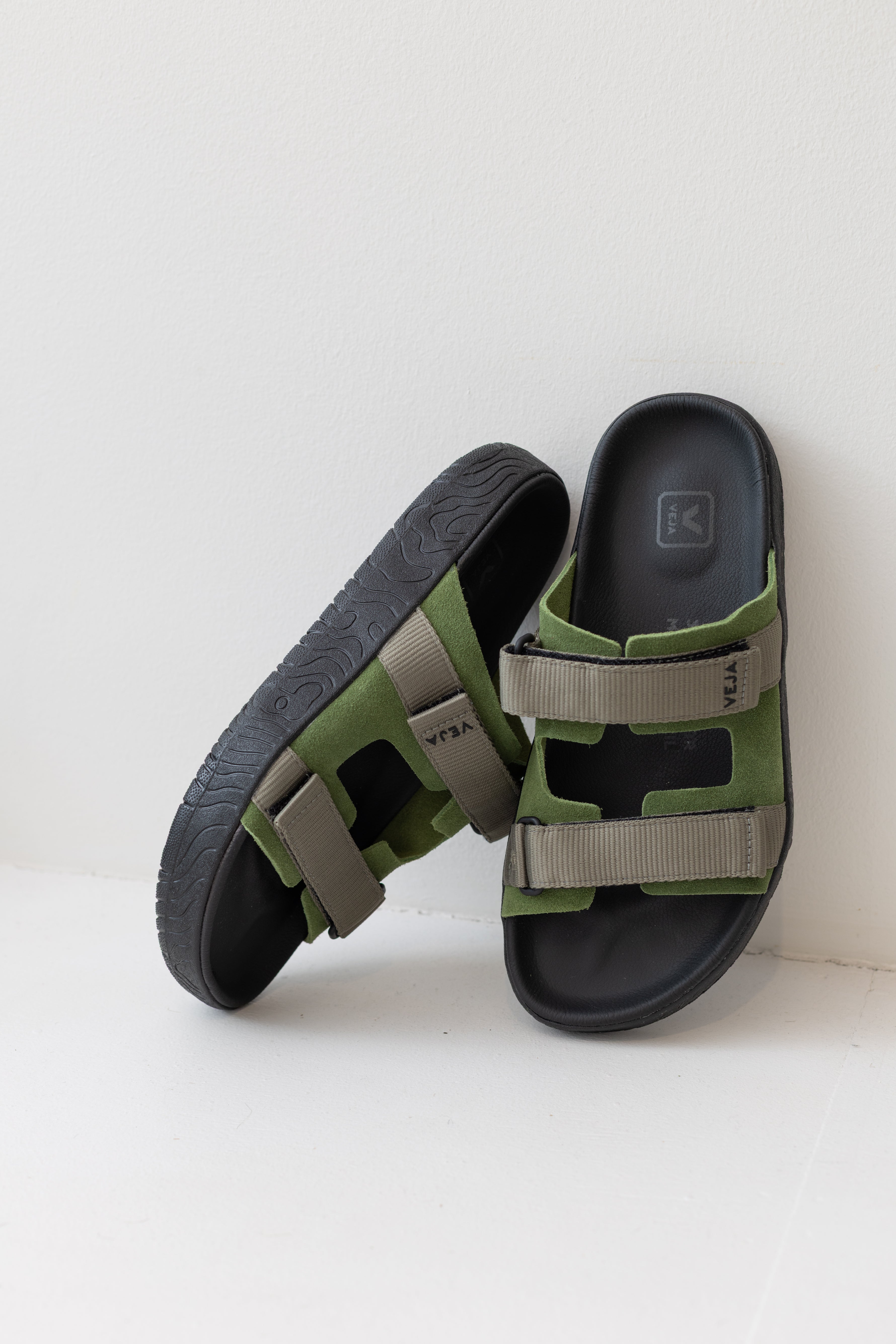 Veja Arpoador slide sandal featuring green suede and gray double straps set on a soft black footbed and lightweight black platform sole at Alas Eius
