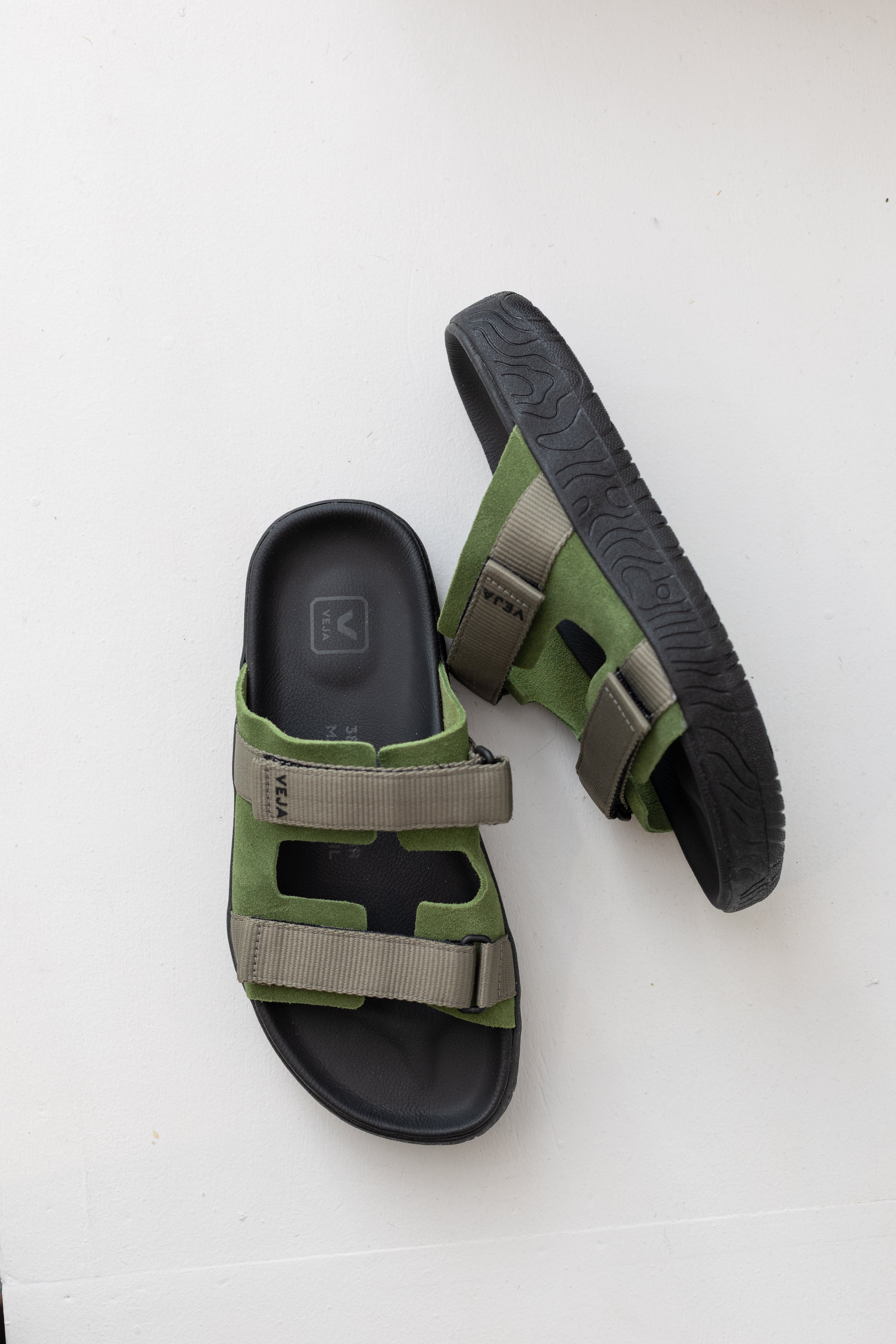 Veja Arpoador slide sandal featuring green suede and gray double straps set on a soft black footbed and lightweight black platform sole at Alas Eius