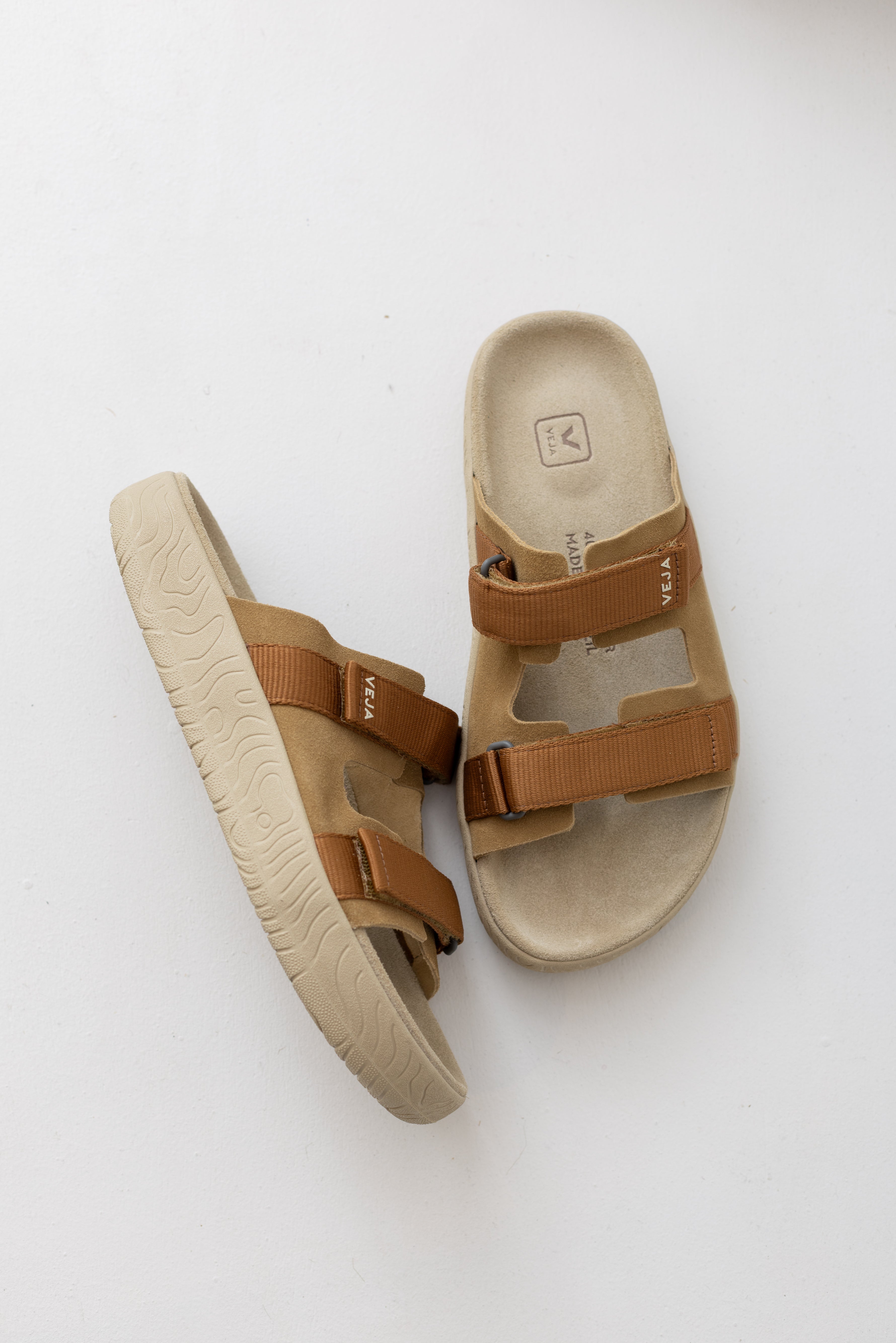 Veja Arpoador slide sandal featuring cognac suede double straps and tan adjustable straps set on a beige footbed and lightweight off white platform sole at Alas Eius.