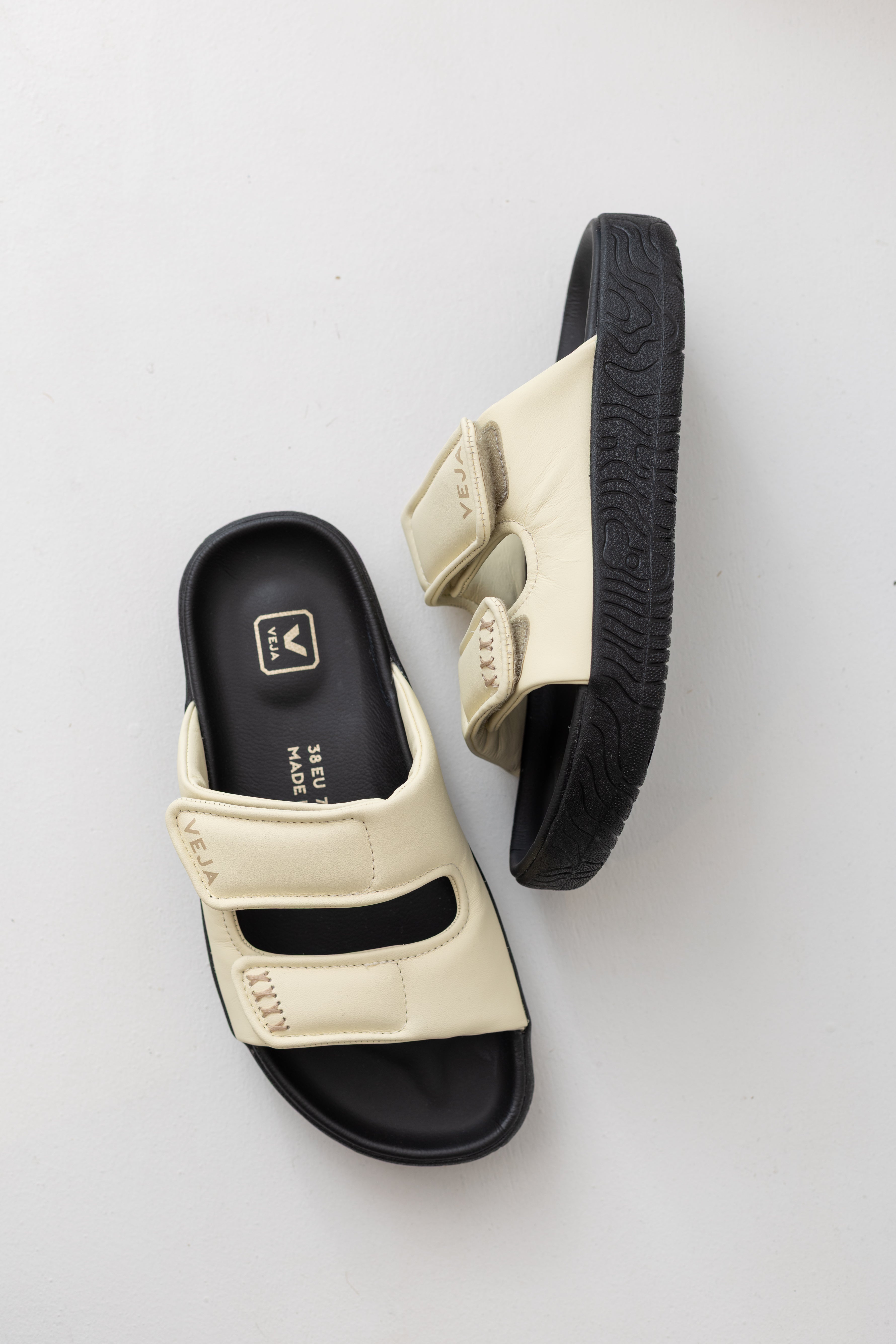 Veja sneaker brand cashew off white leather etna bold slide sandal with black platform sole at Alas Eius. 