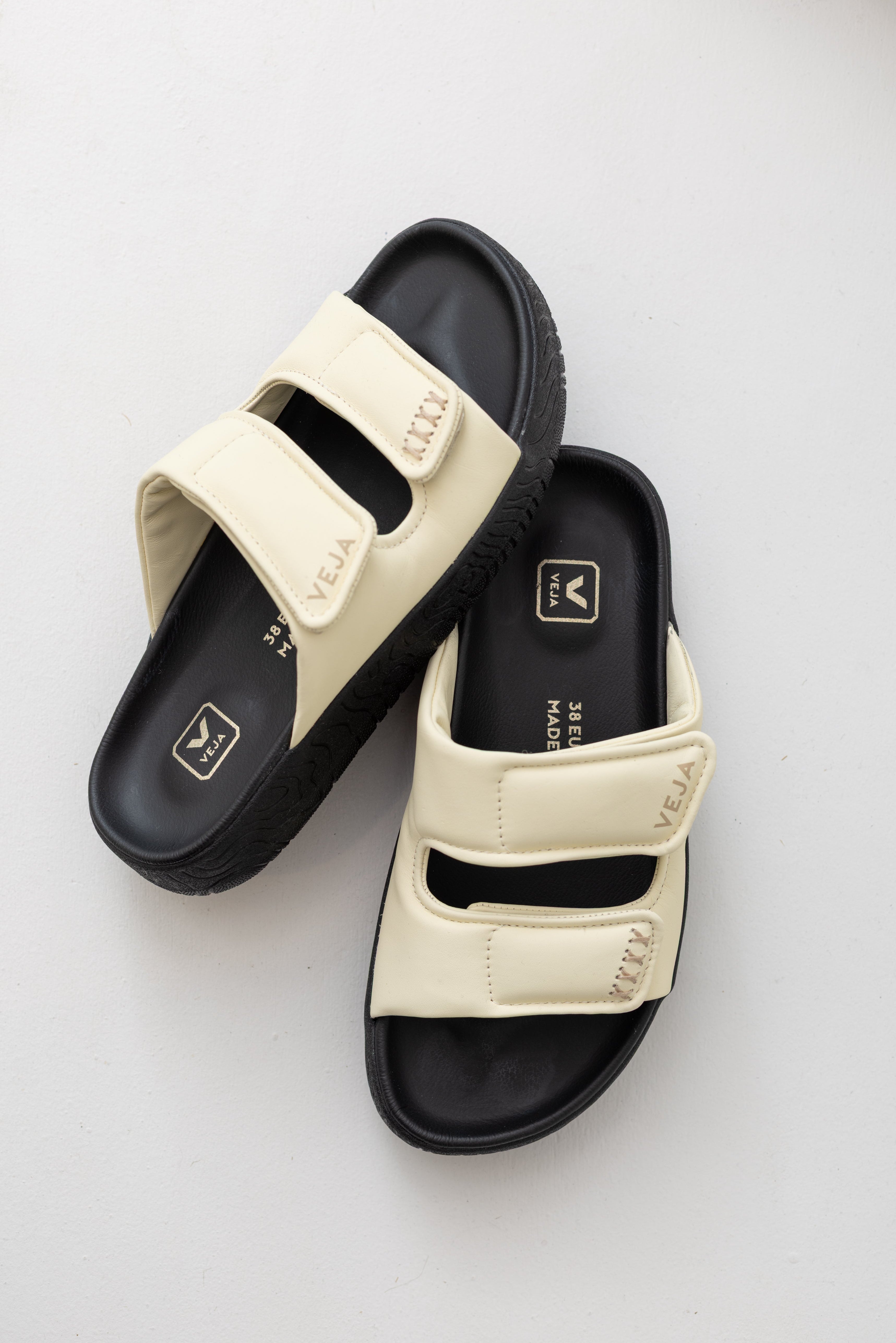 Veja sneaker brand cashew off white leather etna bold slide sandal with black platform sole at Alas Eius. 
