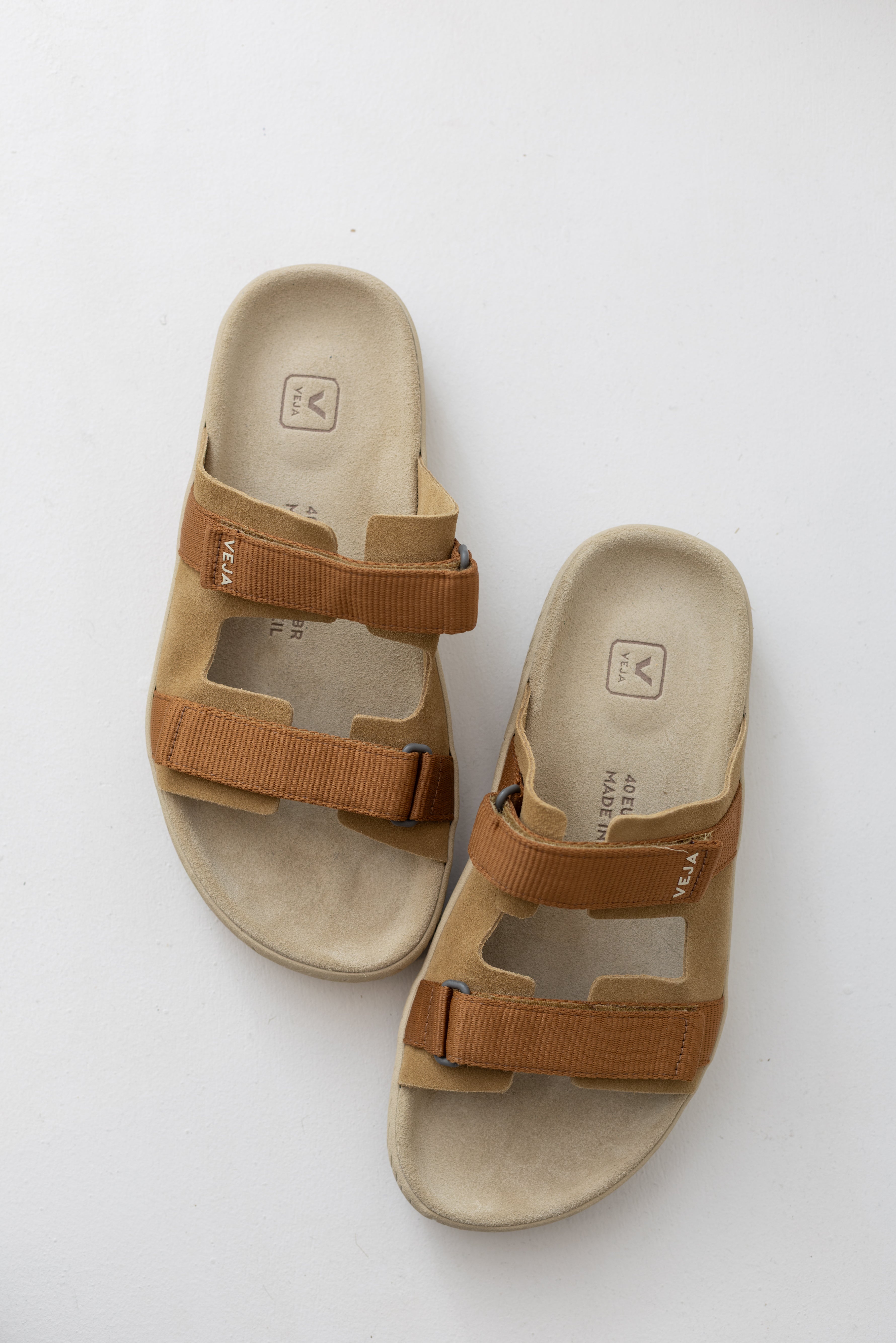 Veja Arpoador slide sandal featuring cognac suede double straps and tan adjustable straps set on a beige footbed and lightweight off white platform sole at Alas Eius.