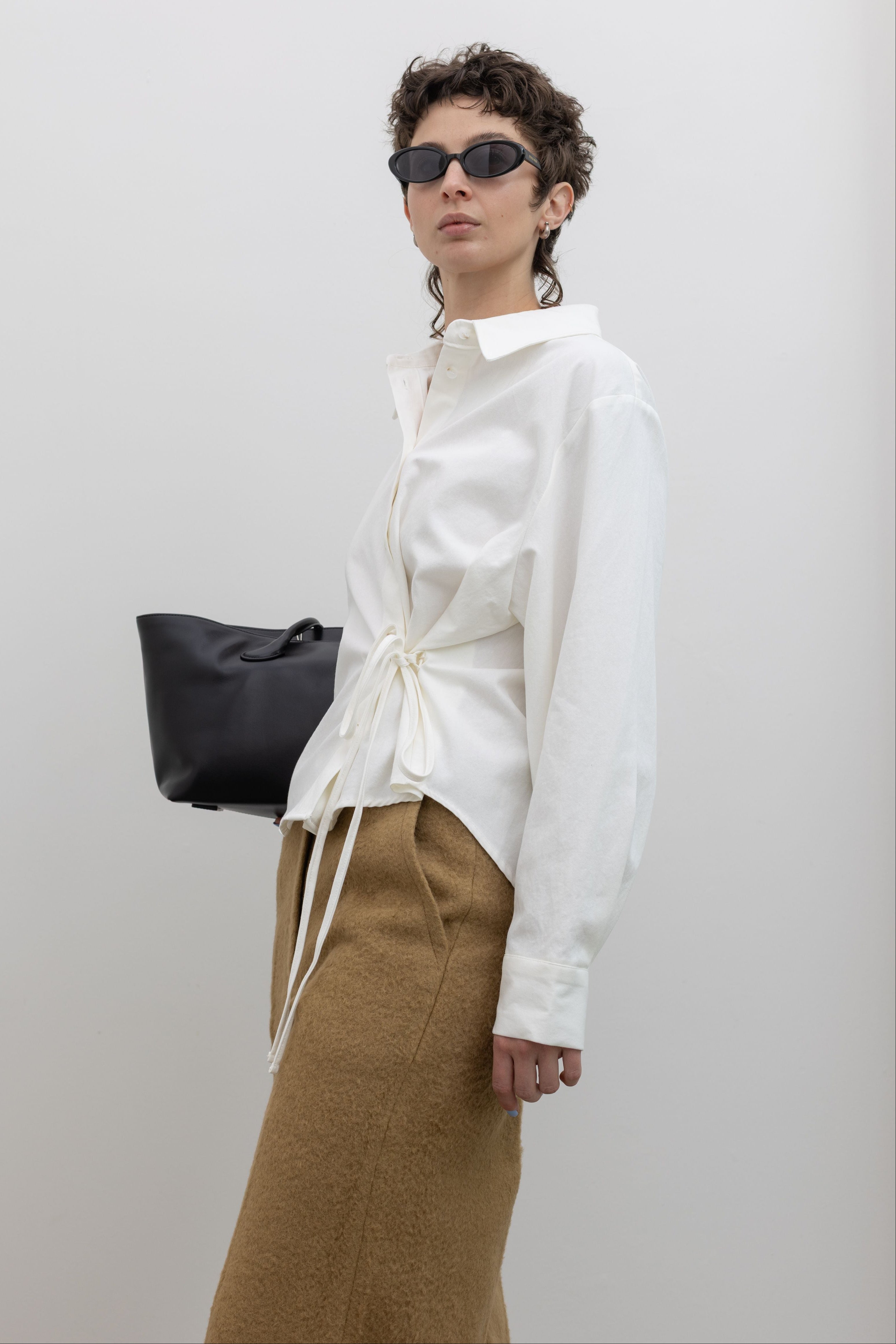 Fashion forward white asymmetrical button down with side tie flattering fit at alas Eius 