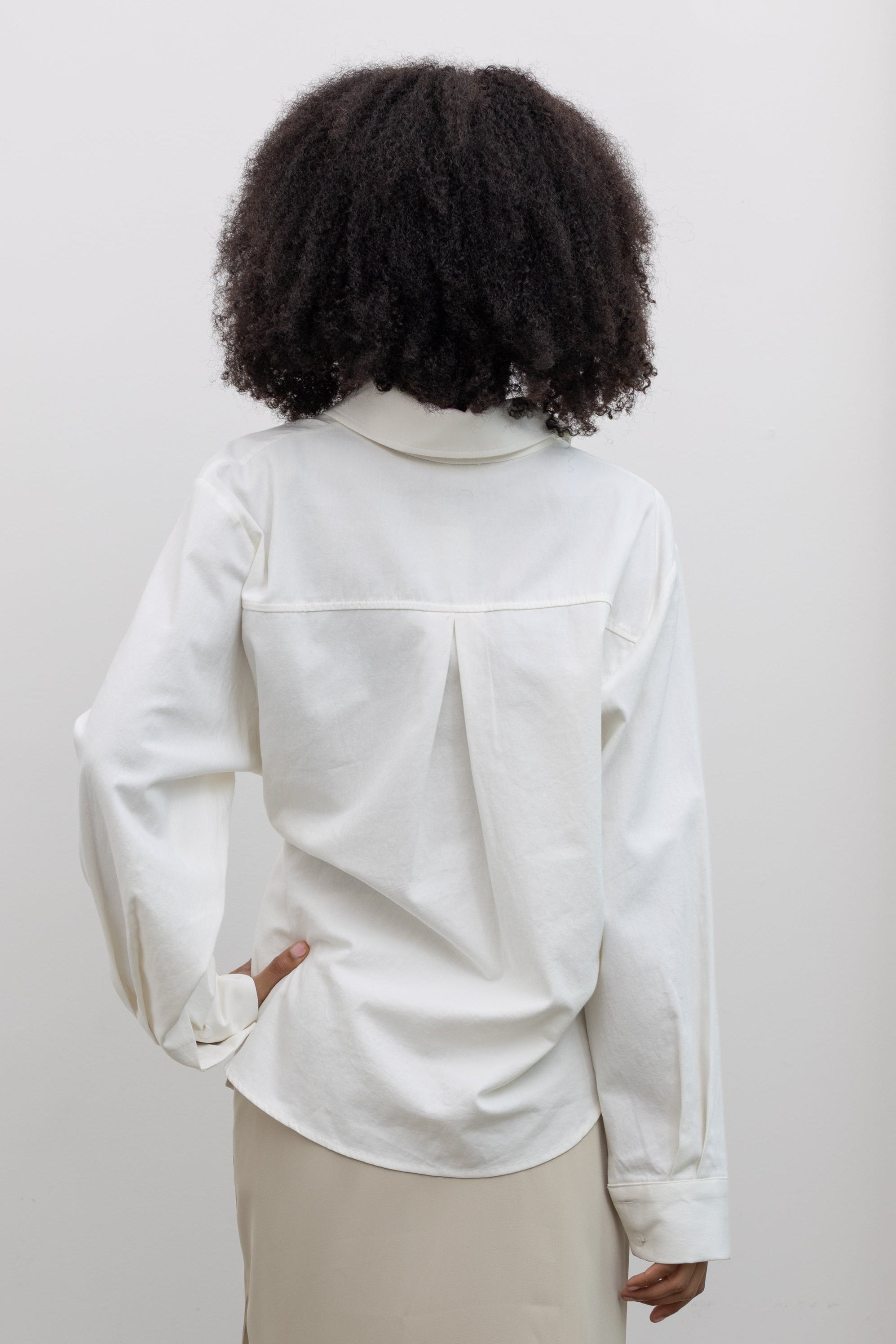 Alas Eius Women's Cotton Side Tie Button Down Top styled with a Beige Satin Wrap Skirt for a modern minimalist look at Alas Eius