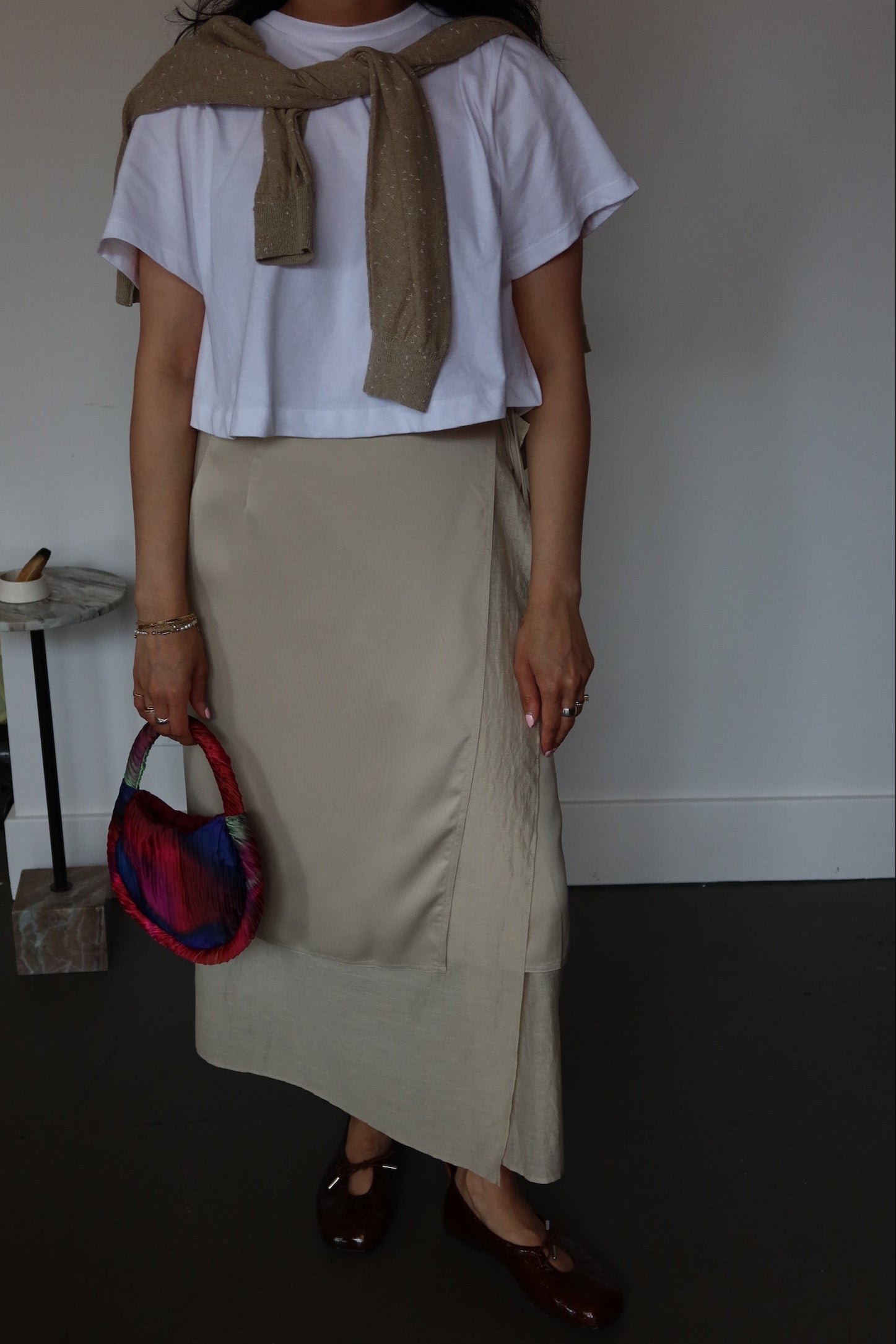Elegant beige midi wrap skirt in satin with cotton lining and adjustable fit, modern wardrobe essential at Alas Eius