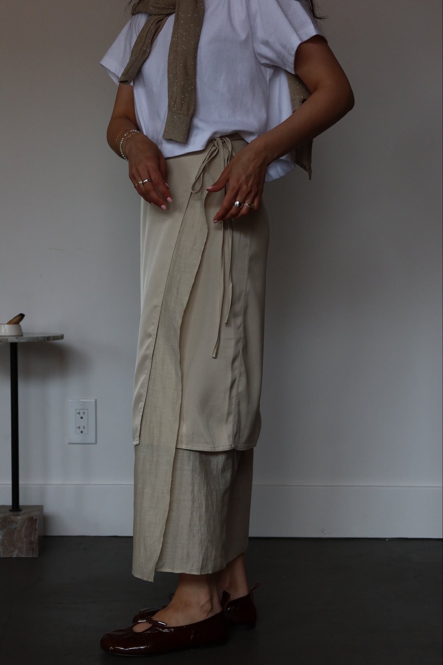 Beige satin wrap skirt with soft tie detail and layered hem effect, minimalist luxury women's skirt at Alas Eius