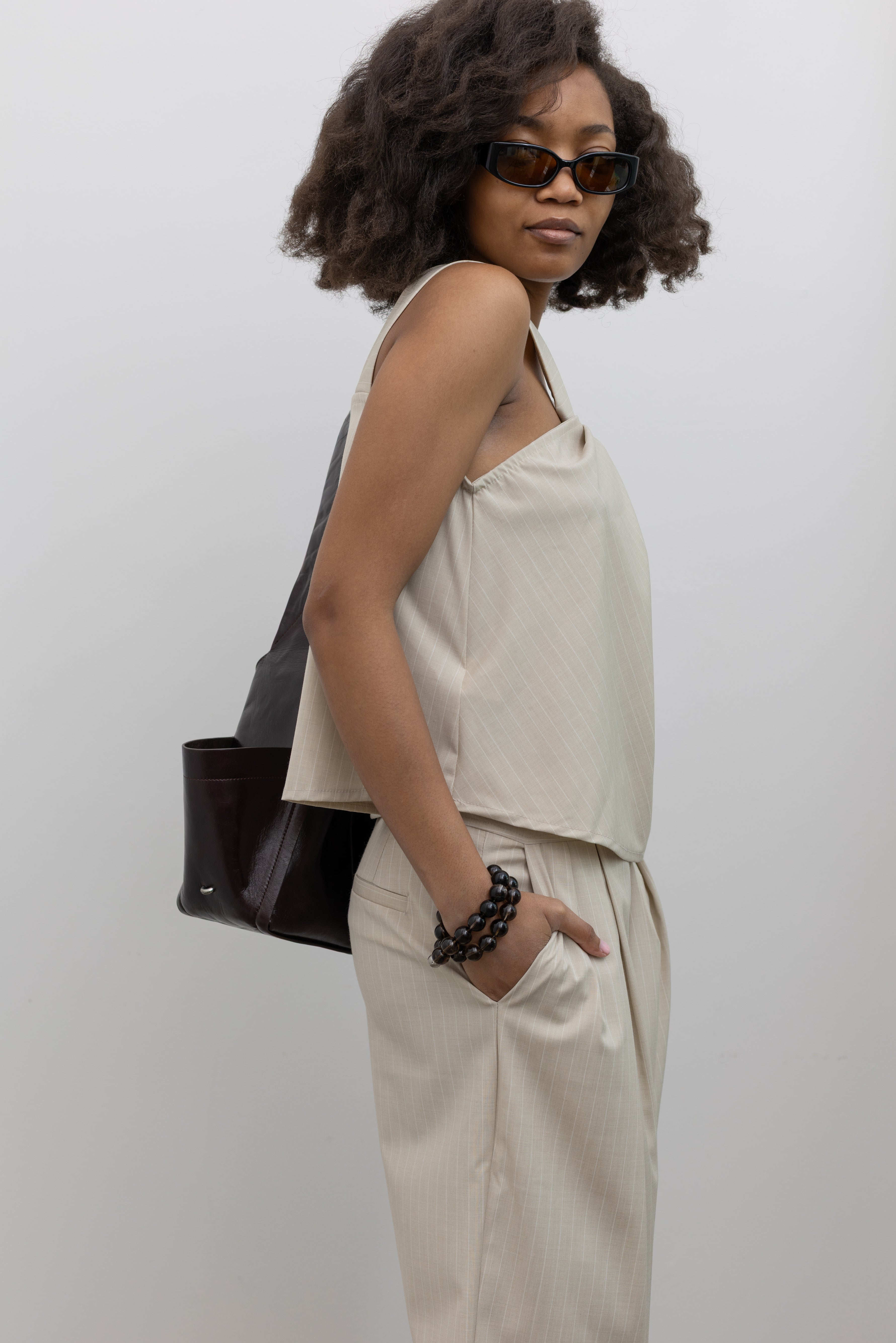 Collective architectural twist neck pinstripe halter blouse with elegant draped silhouette at Alas Eius