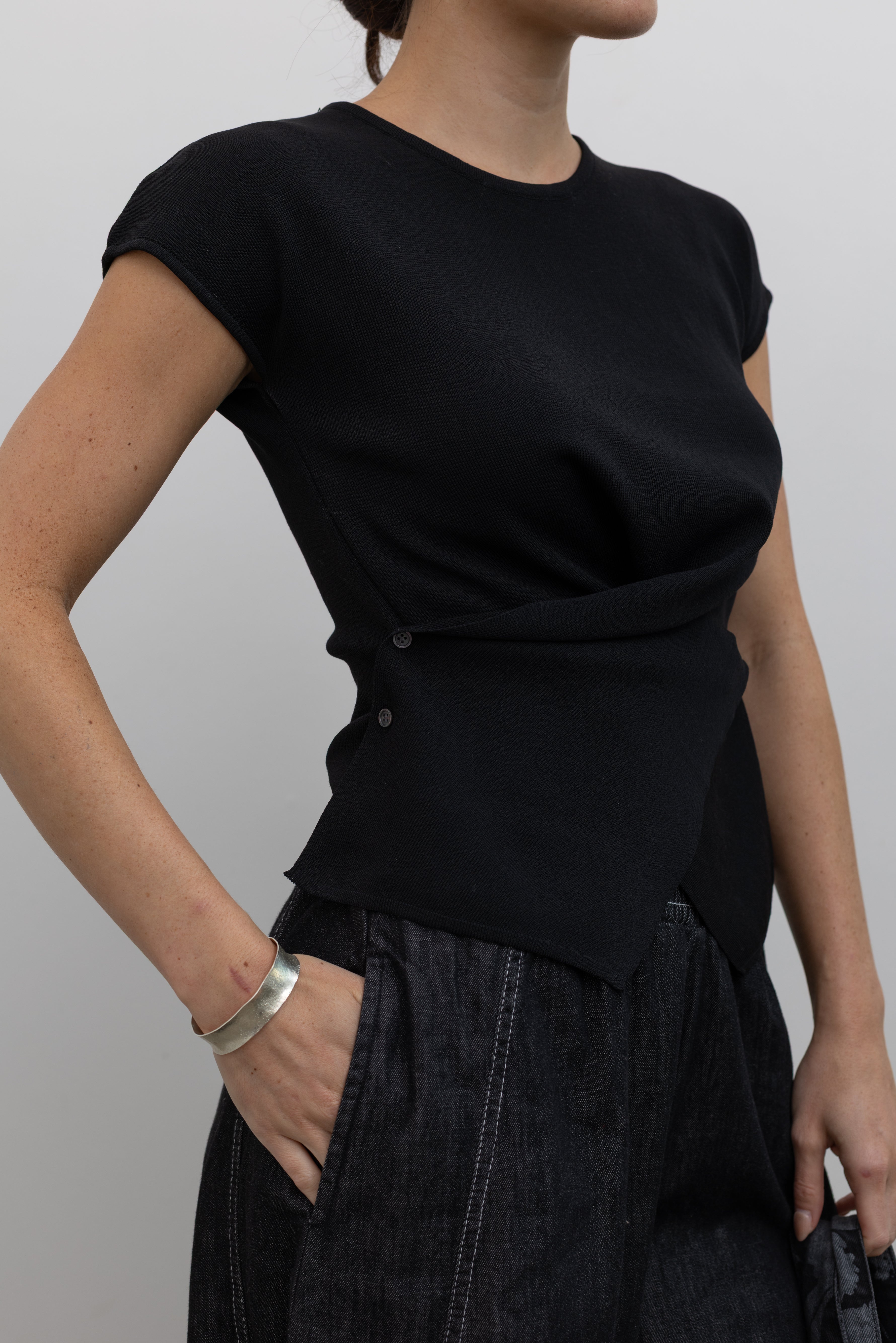 Collective fluid acrylic knit top with architectural pointed hem at Alas Eius