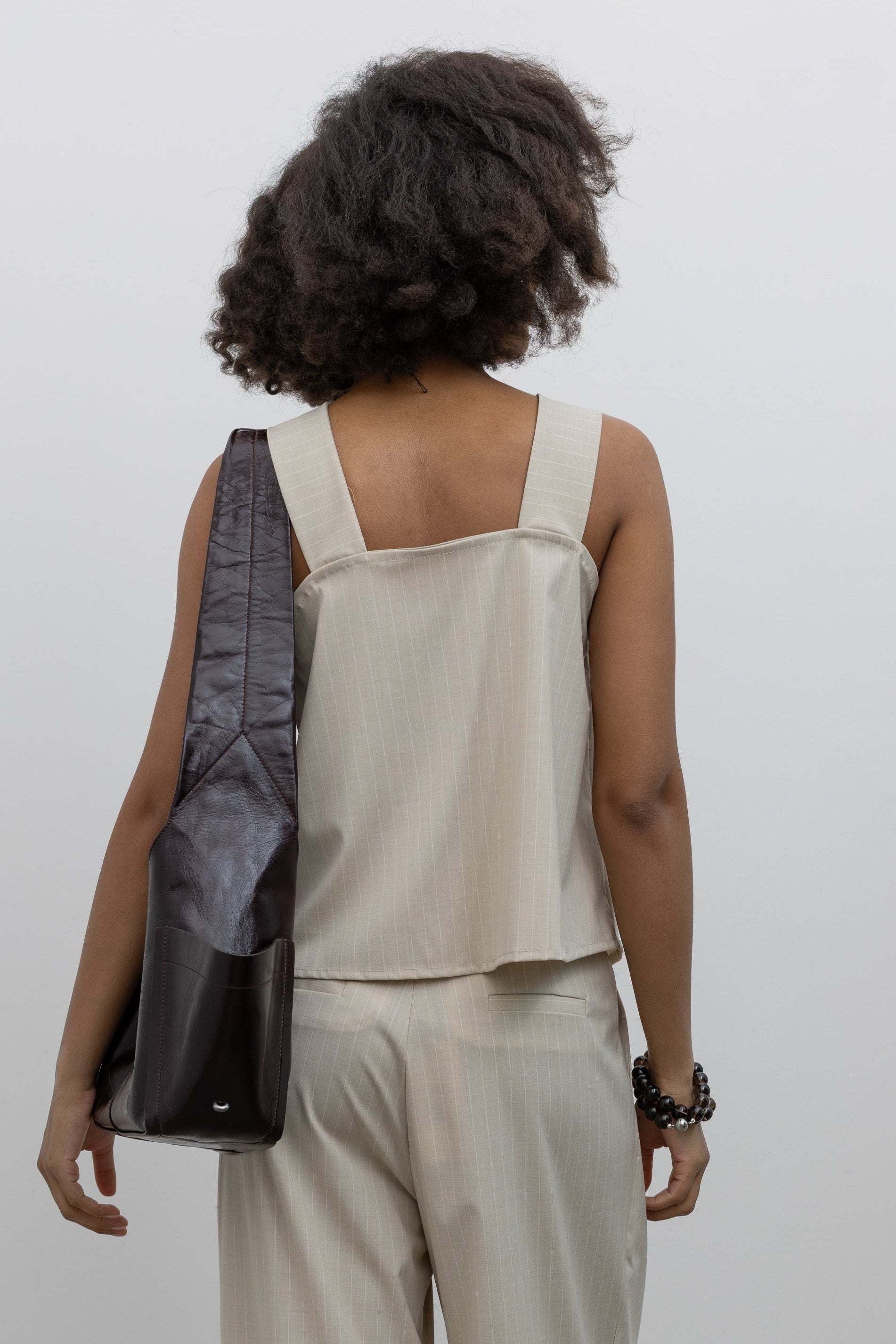 Collective modern pinstripe halter top with asymmetric drape and clean structural folds at Alas Eius