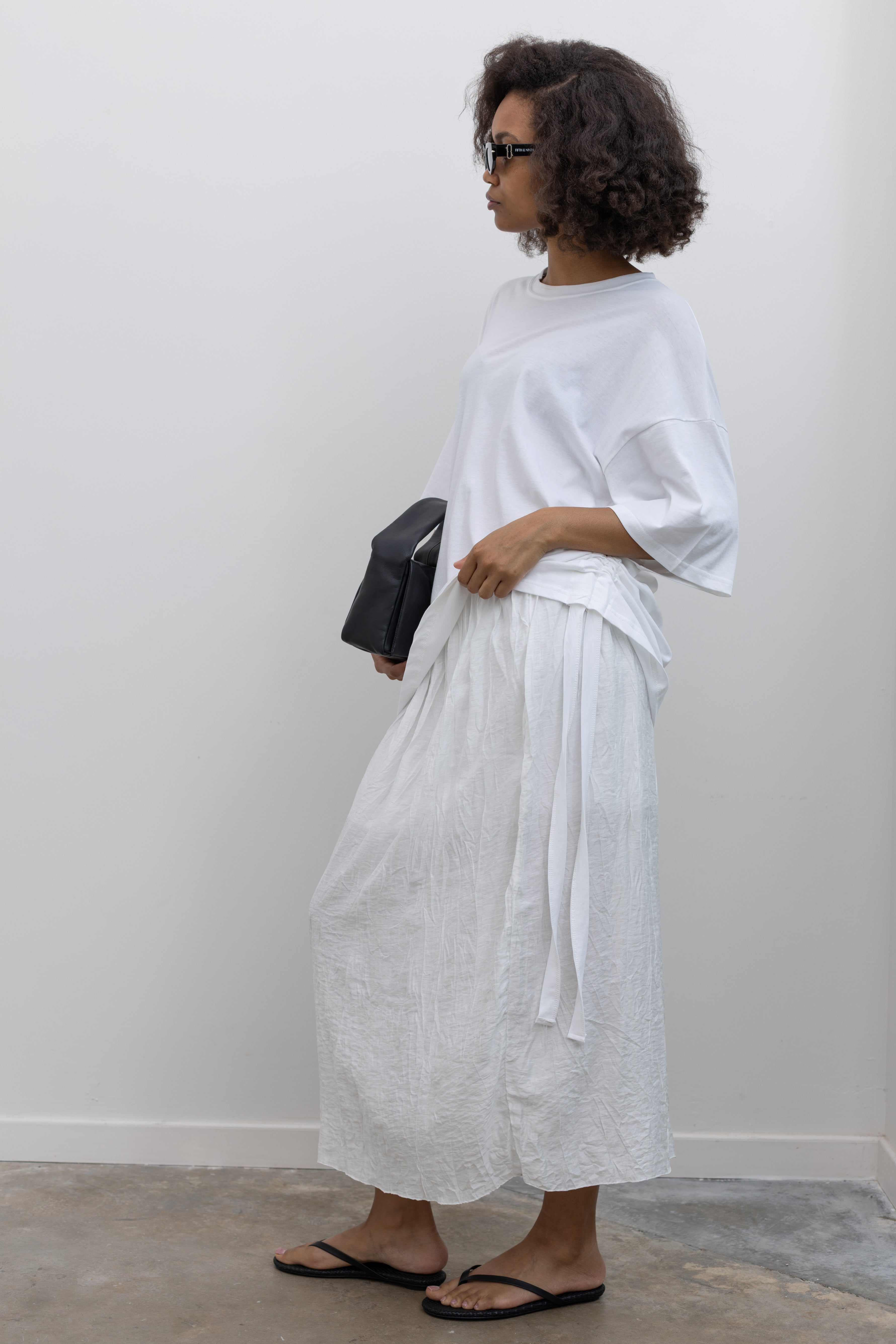 Collective breezy crinkle-textured cotton blend midi skirt with an easy elastic waistband at Alas Eius