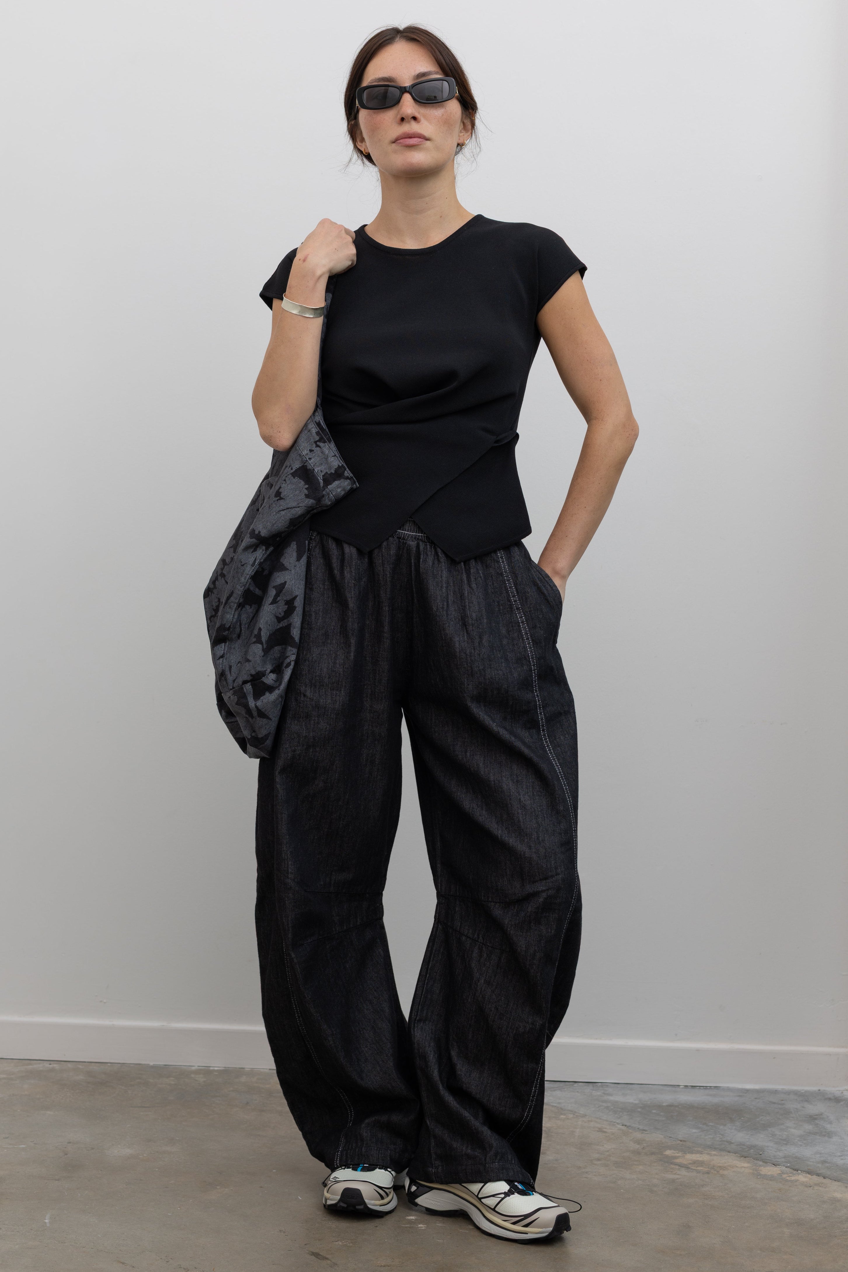 Collective wrap-front knit top with side button closures and relaxed drape at Alas Eius