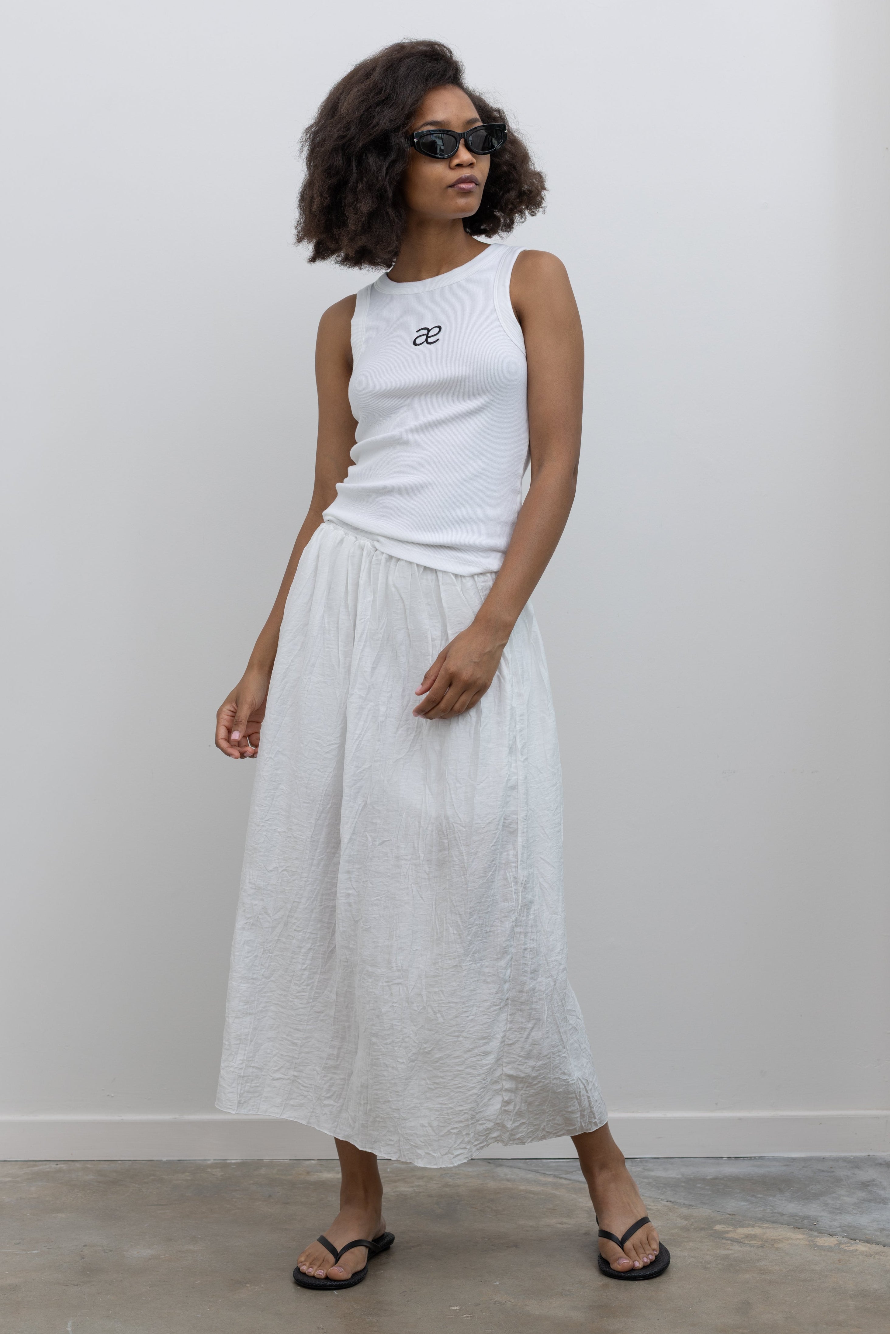 Collective crinkle-textured cotton blend midi skirt with a gathered elastic waistband at Alas Eius