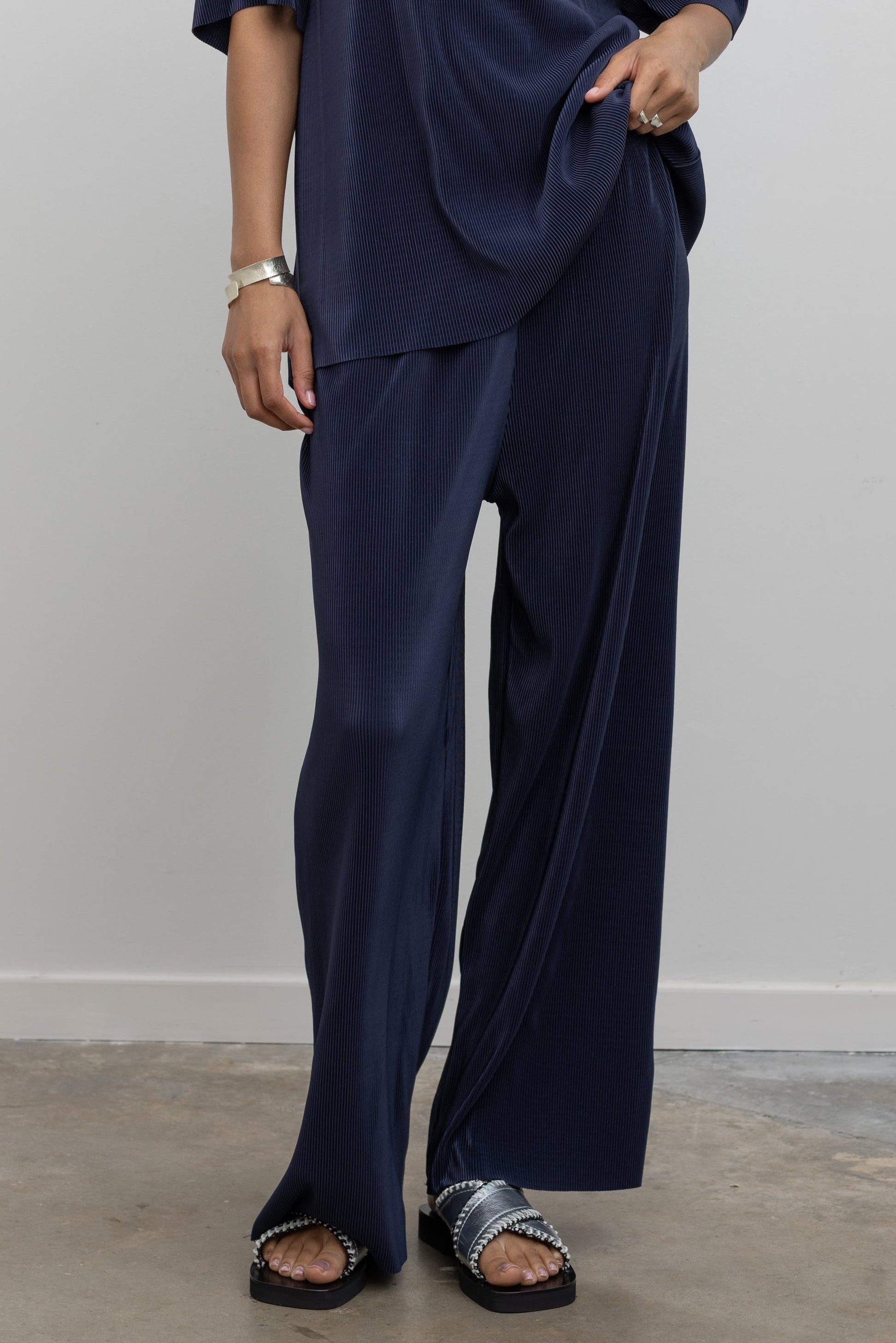 Collective dark navy micro-pleated wide-leg pants with elastic waistband at Alas Eius