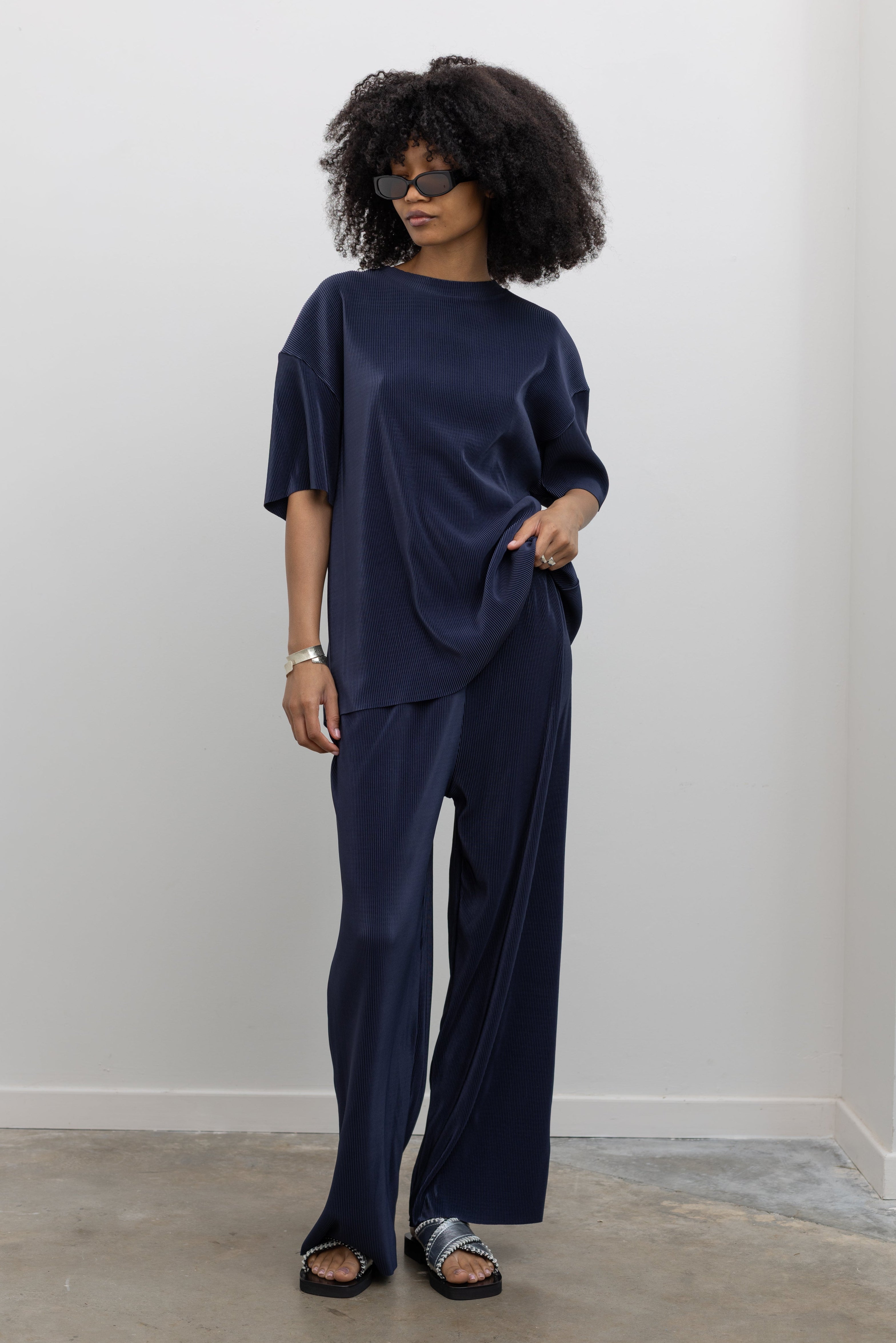 Collective dark navy micro-pleated wide-leg pants with elastic waistband at Alas Eius