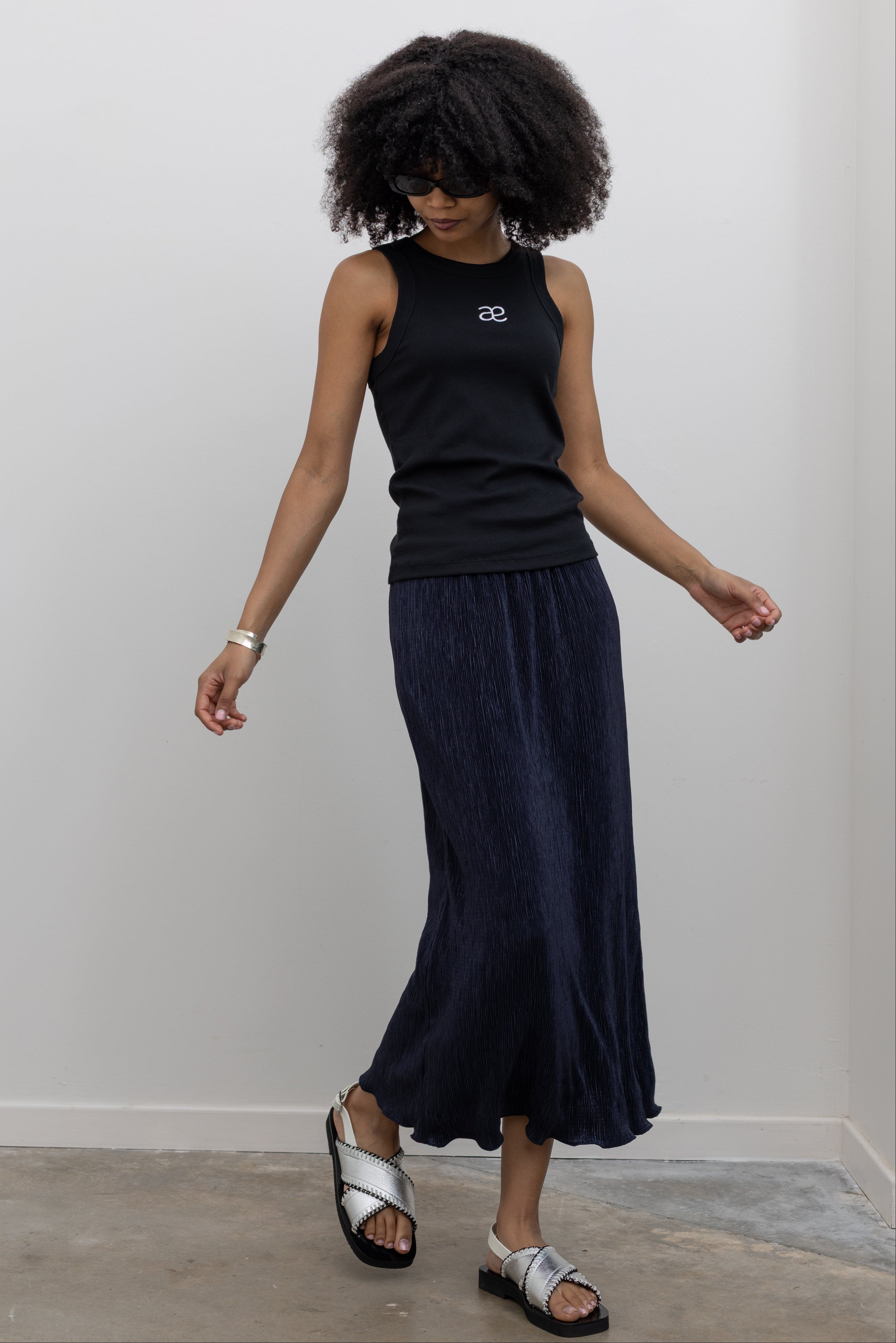 Collective dark navy plissé midi skirt with micro-pleats at Alas Eius