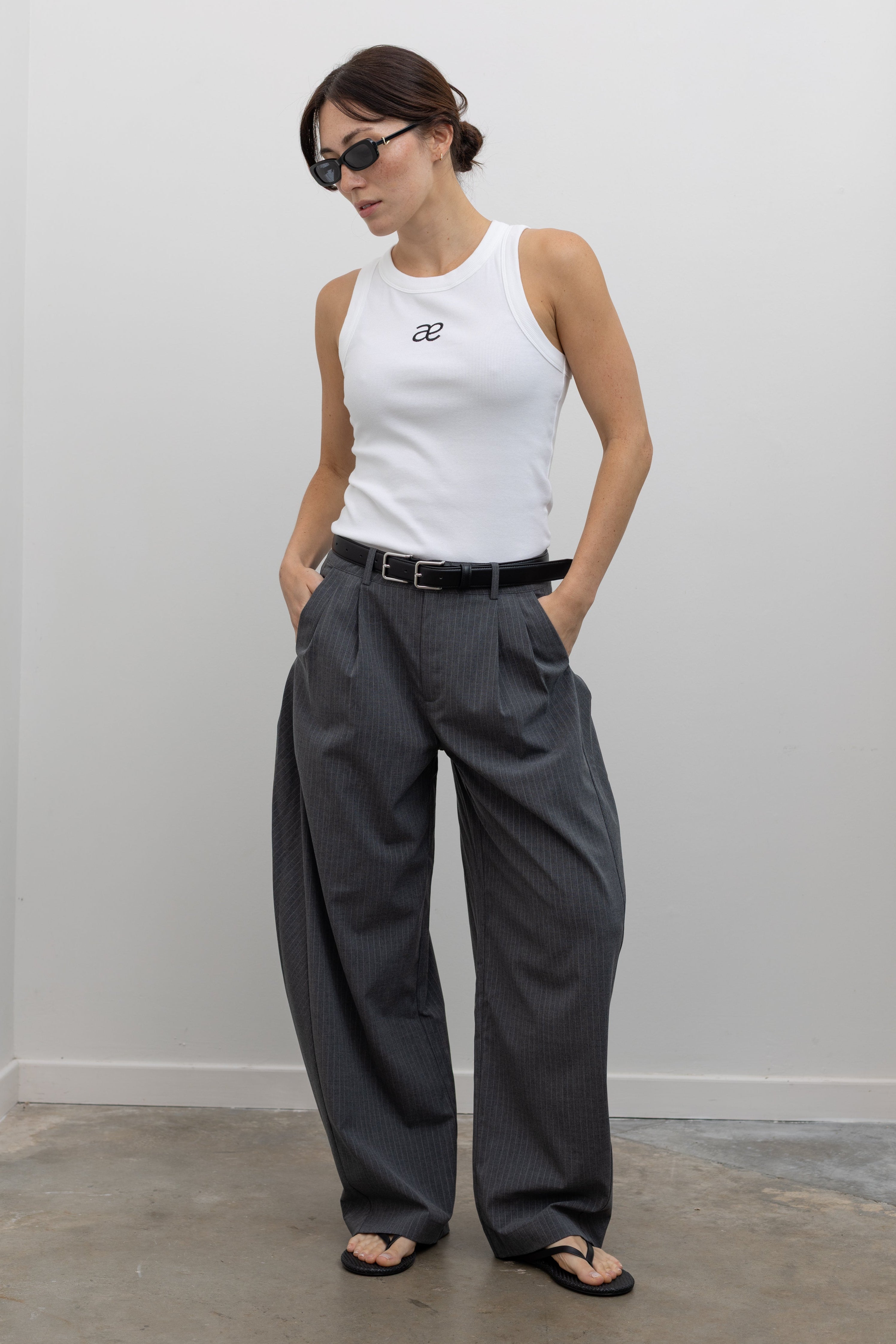 Collective elevated charcoal pinstripe trousers with deep pleats and barrel leg shape at Alas Eius