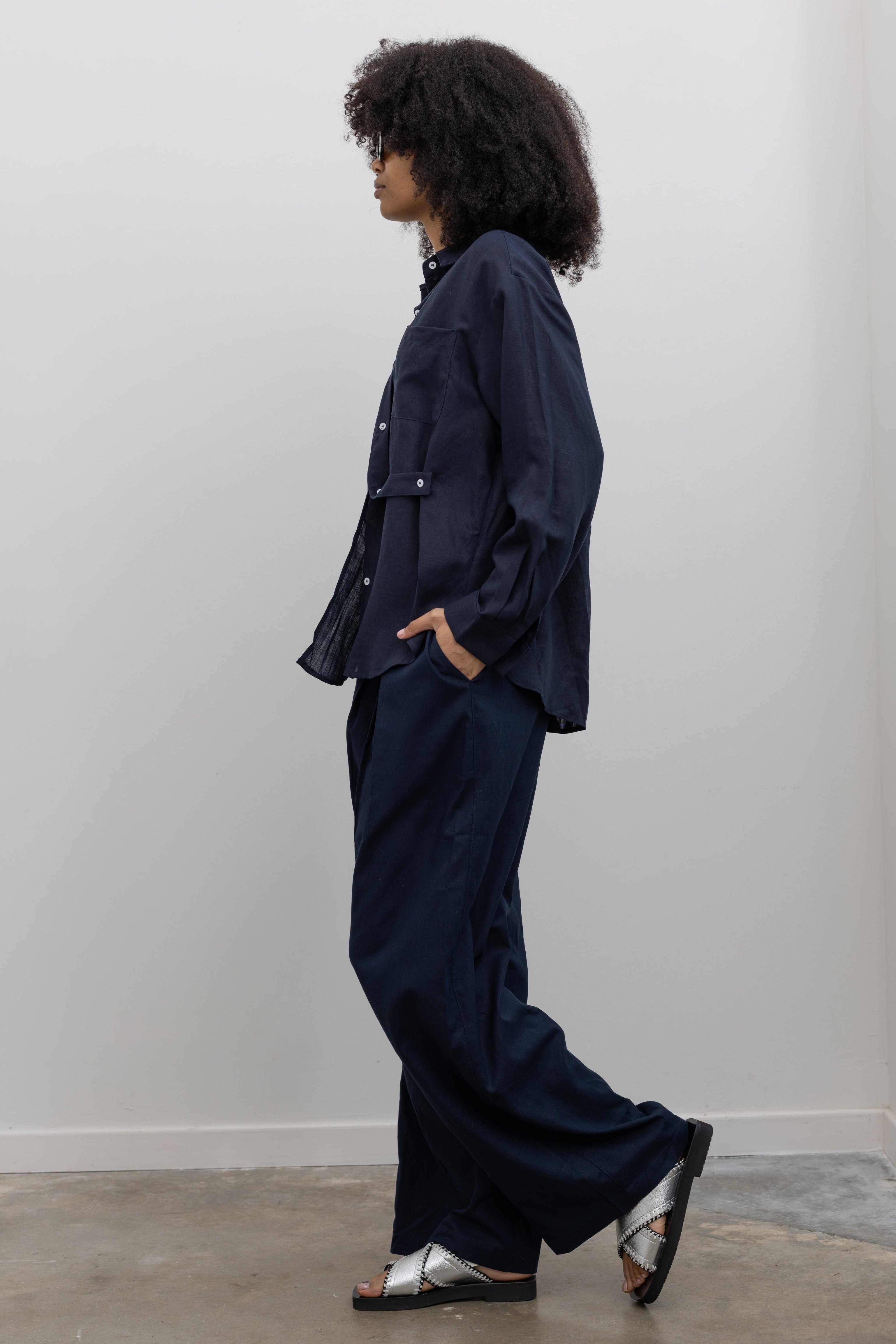 Collective minimalist Ink Linen Tuck Pants featuring fluid tailoring and side pockets at Alas Eius