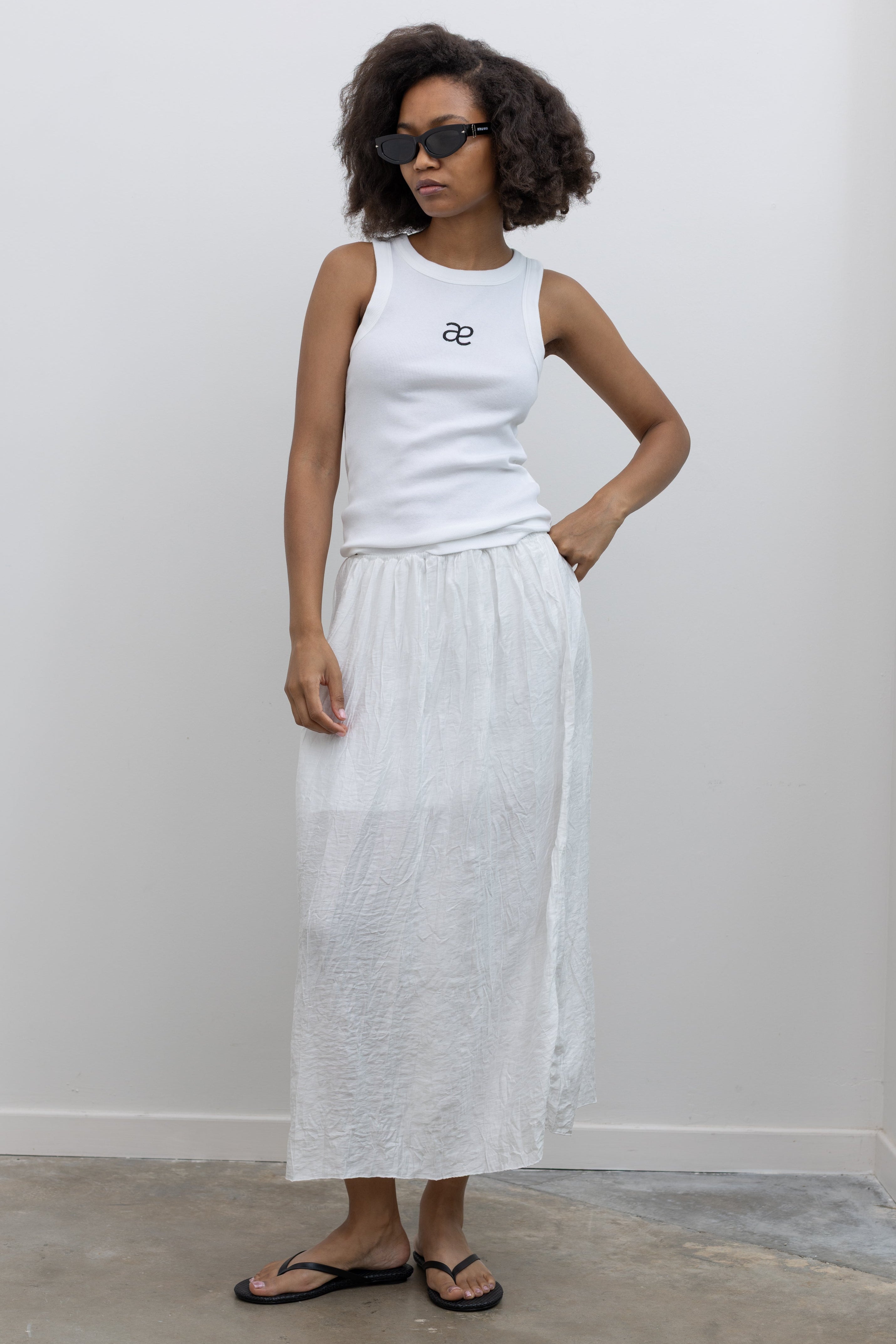Collective relaxed crinkle cotton midi skirt with an effortless drape at Alas Eius