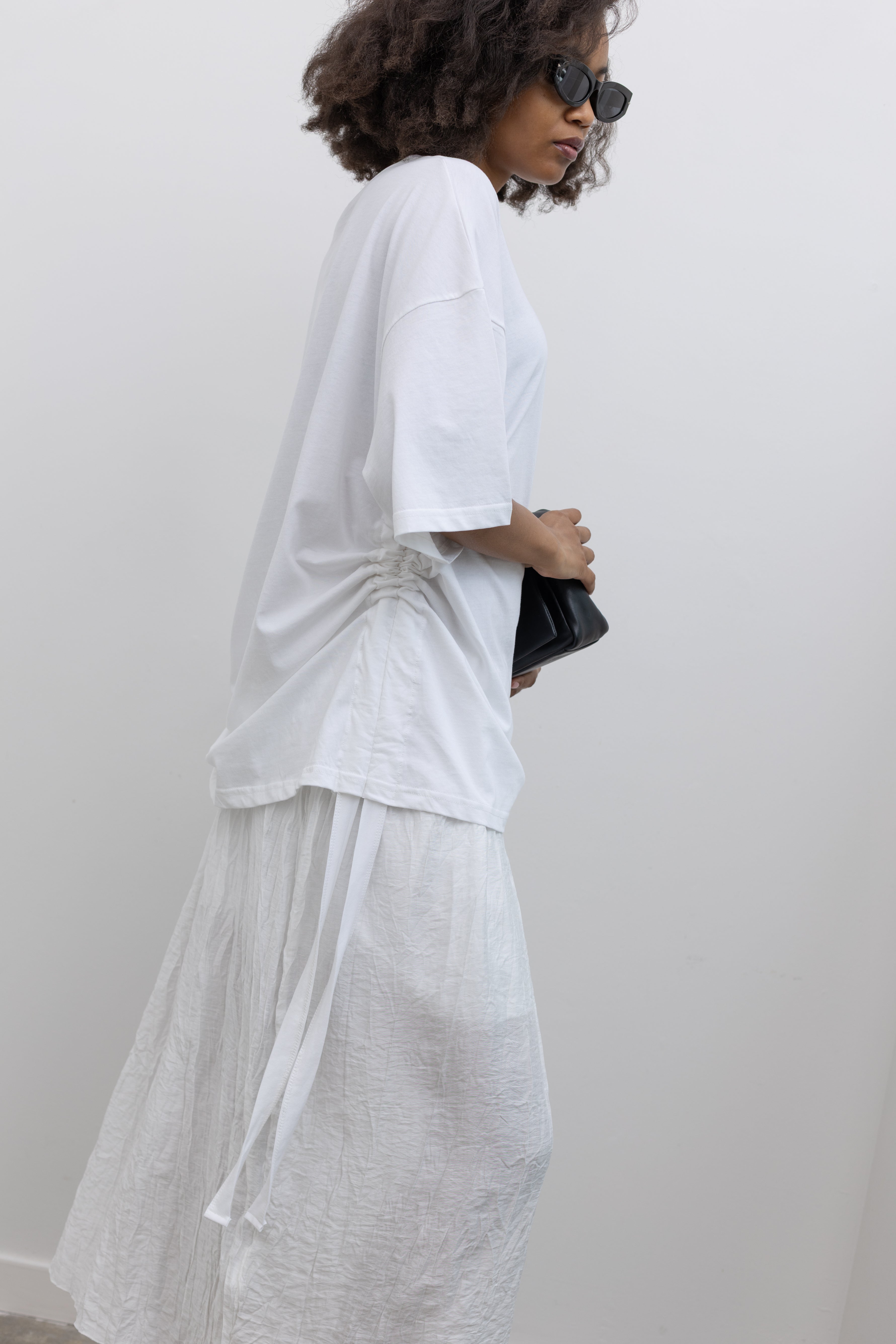Collective oversized crewneck cotton tee with side-tunnel drawstrings at Alas Eius