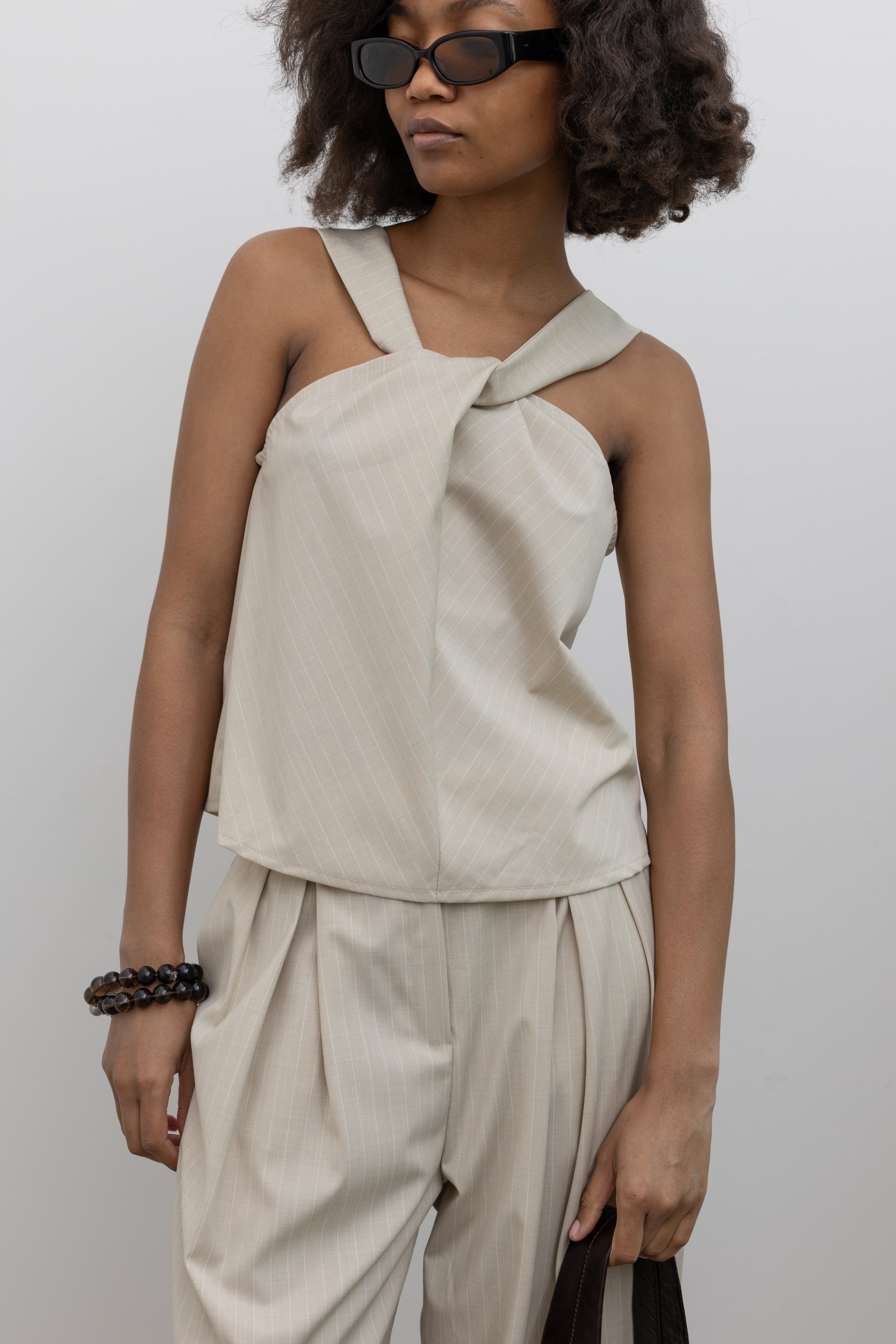 Collective subtle pinstripe sleeveless halter top with twisted neckline and asymmetrical drape at Alas Eius