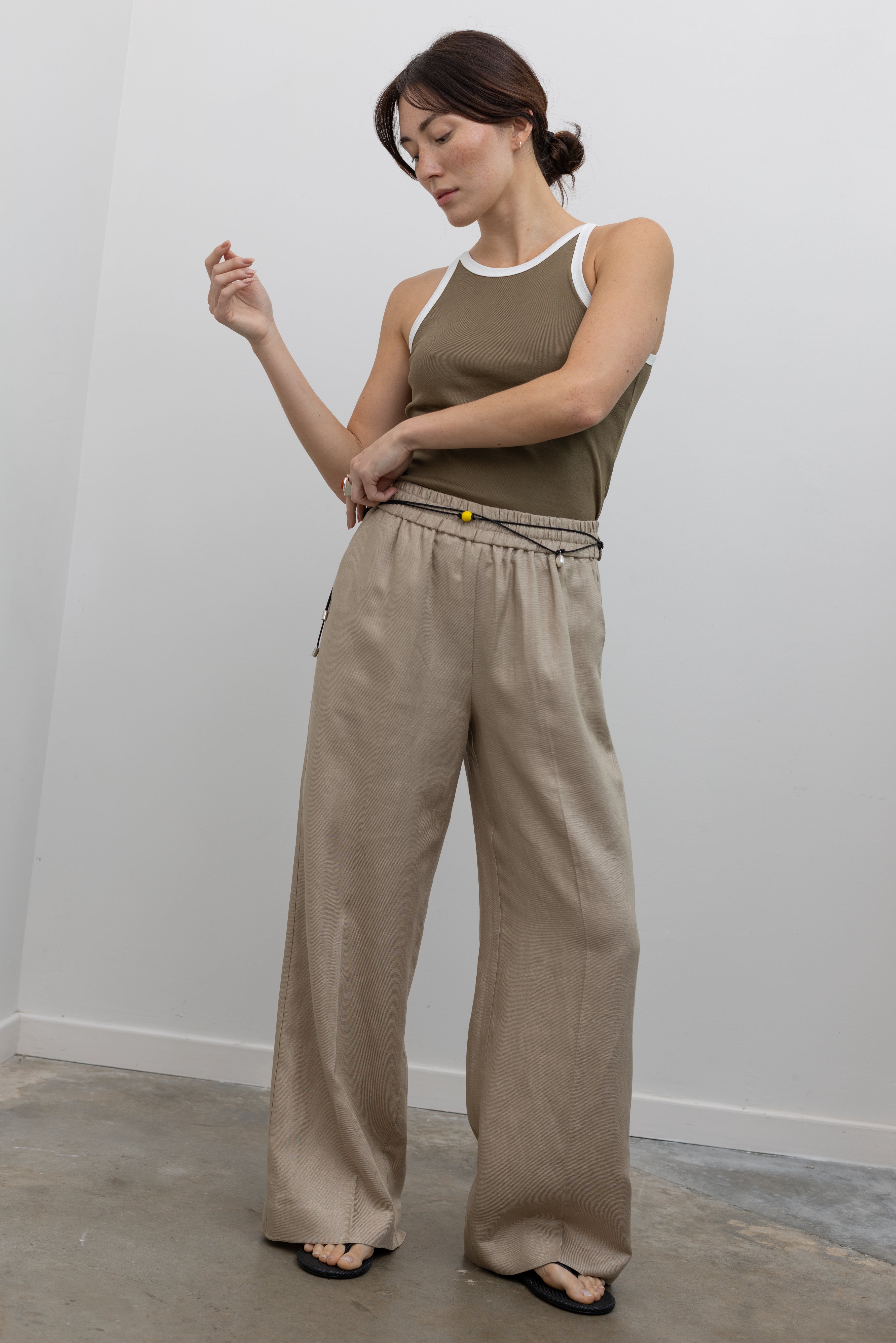 Collective premium beige heavyweight linen trousers with elastic waistband and relaxed drape at Alas Eius
