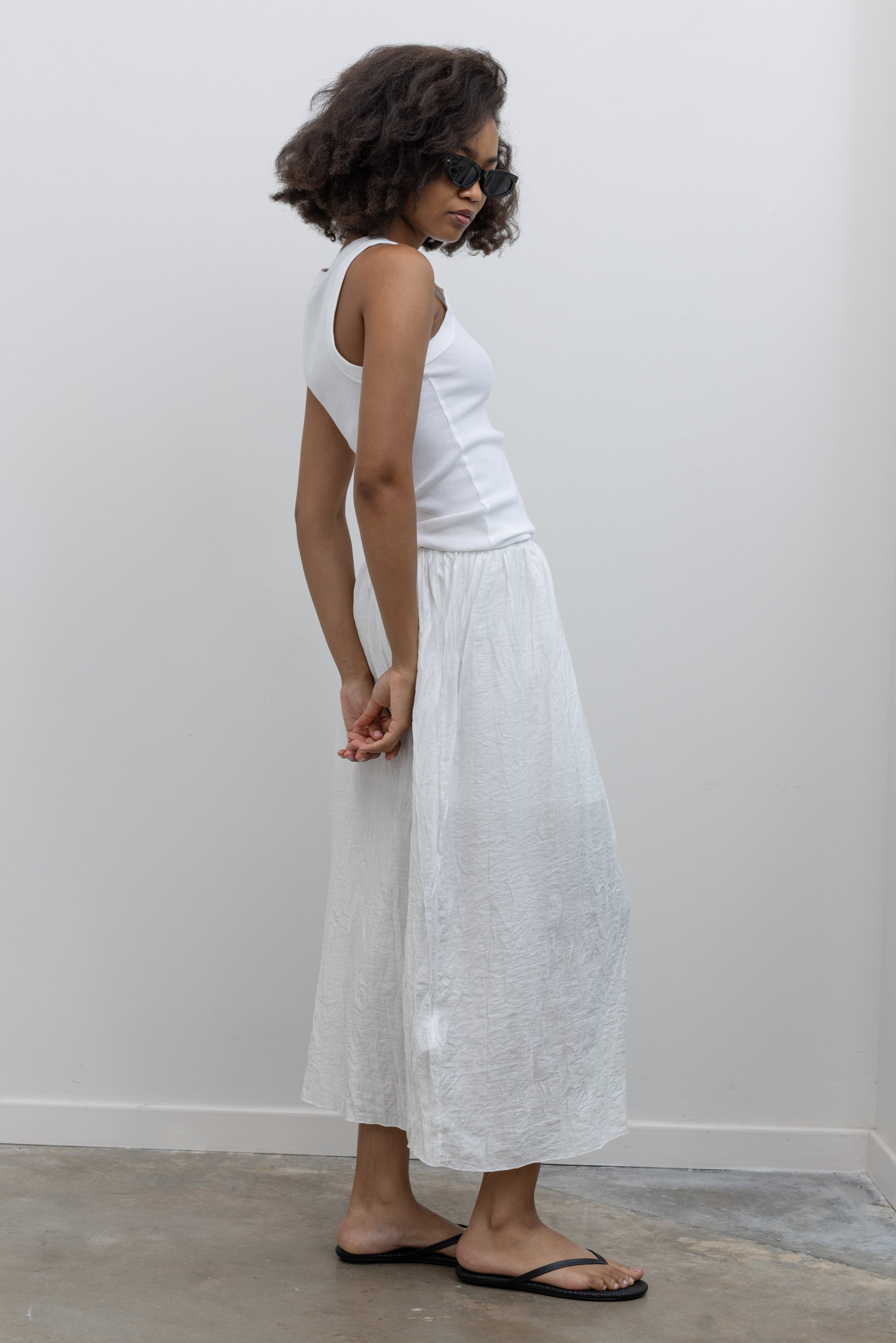 Collective lightweight crinkle midi skirt with a pull-on elastic waist at Alas Eius