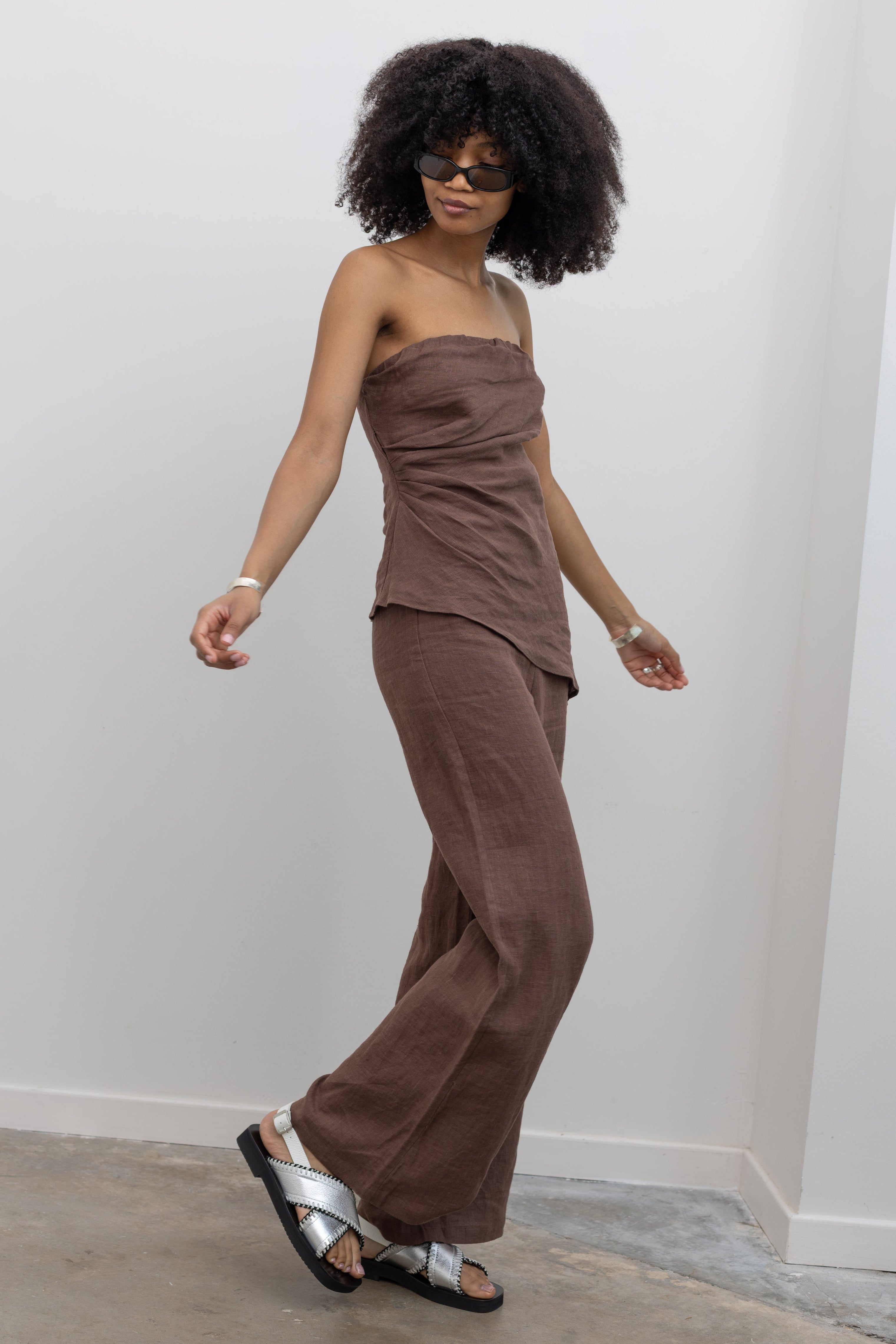 Collective relaxed linen trousers with elongated wide-leg silhouette at Alas Eius