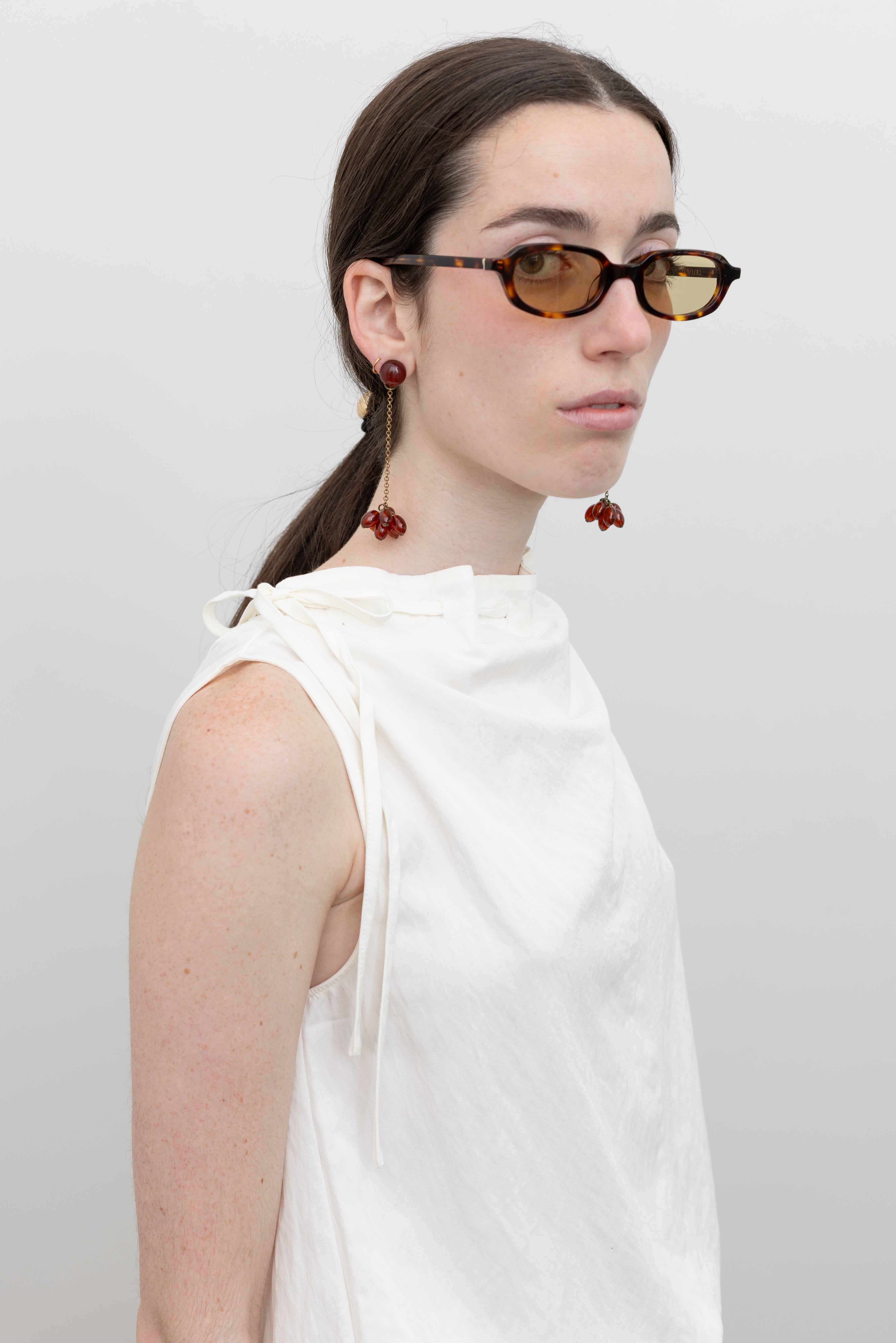 Collective sculptural sleeveless top with cinched mock neck and relaxed bubble hem, perfect for women's capsule wardrobe essentials at Alas Eius