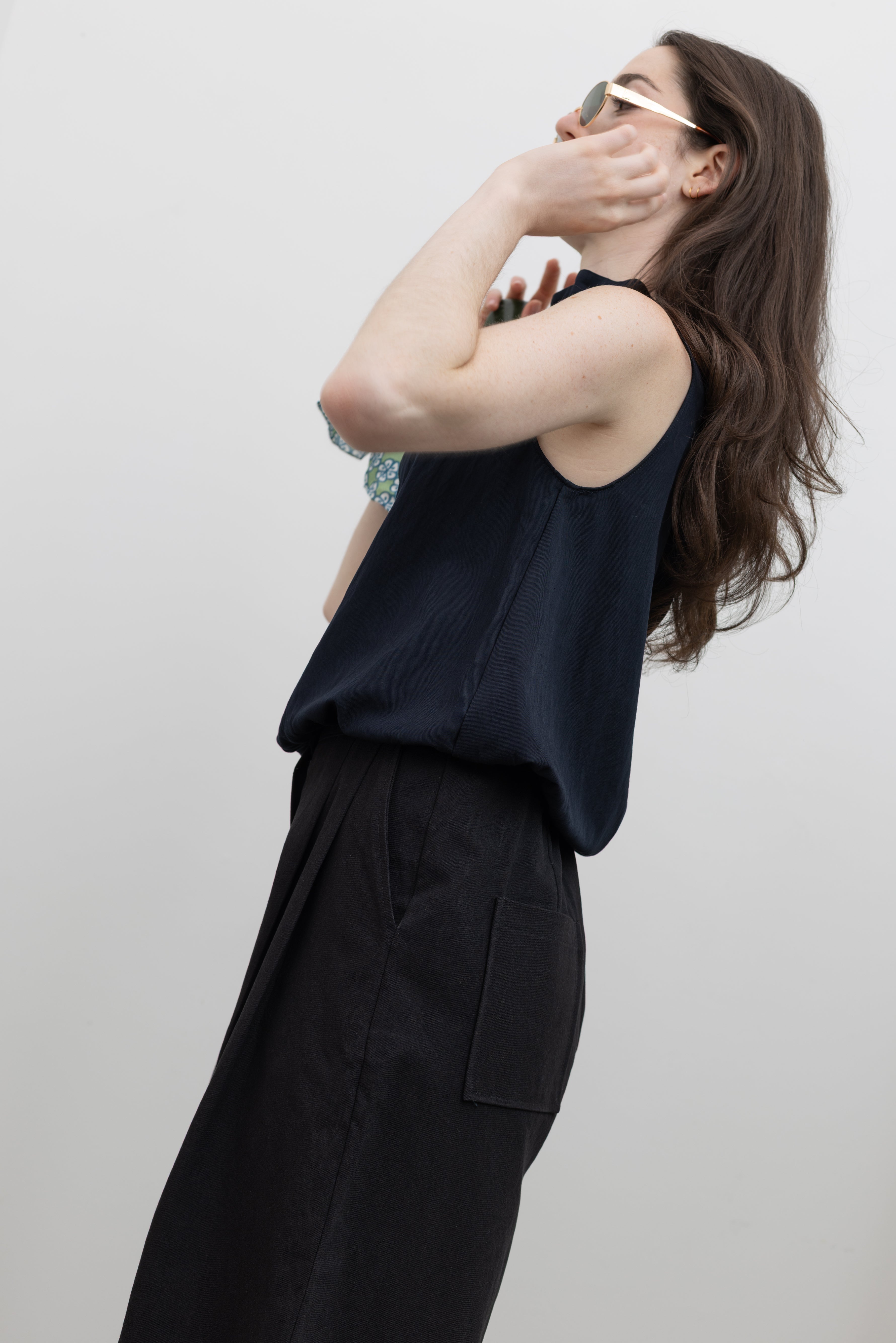 Collective sculptural tank top with adjustable mock neck tie and gathered bubble hem design for contemporary womenswear at Alas Eius.
