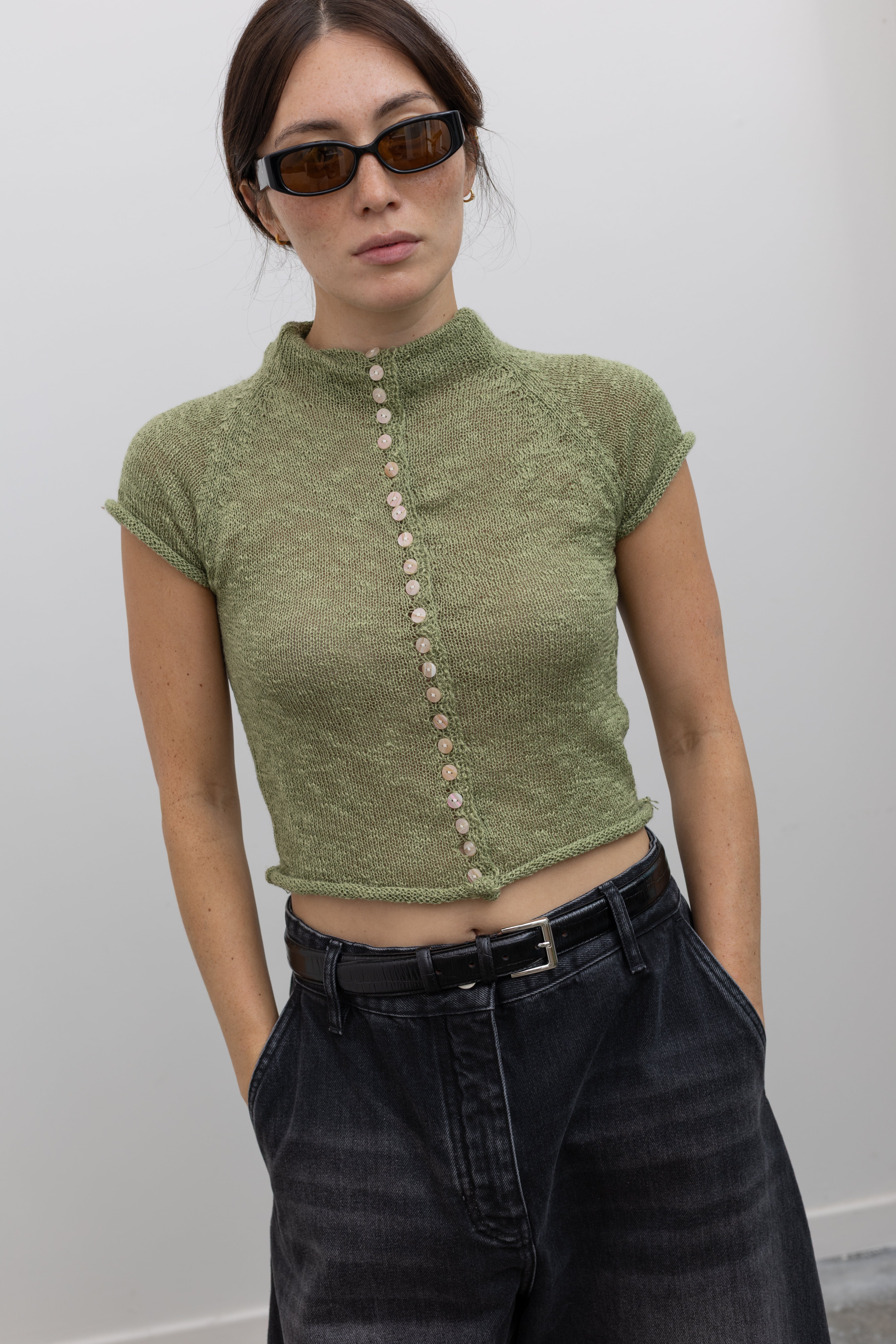 Collective semi-sheer knit mock neck top with decorative front buttons at Alas Eius
