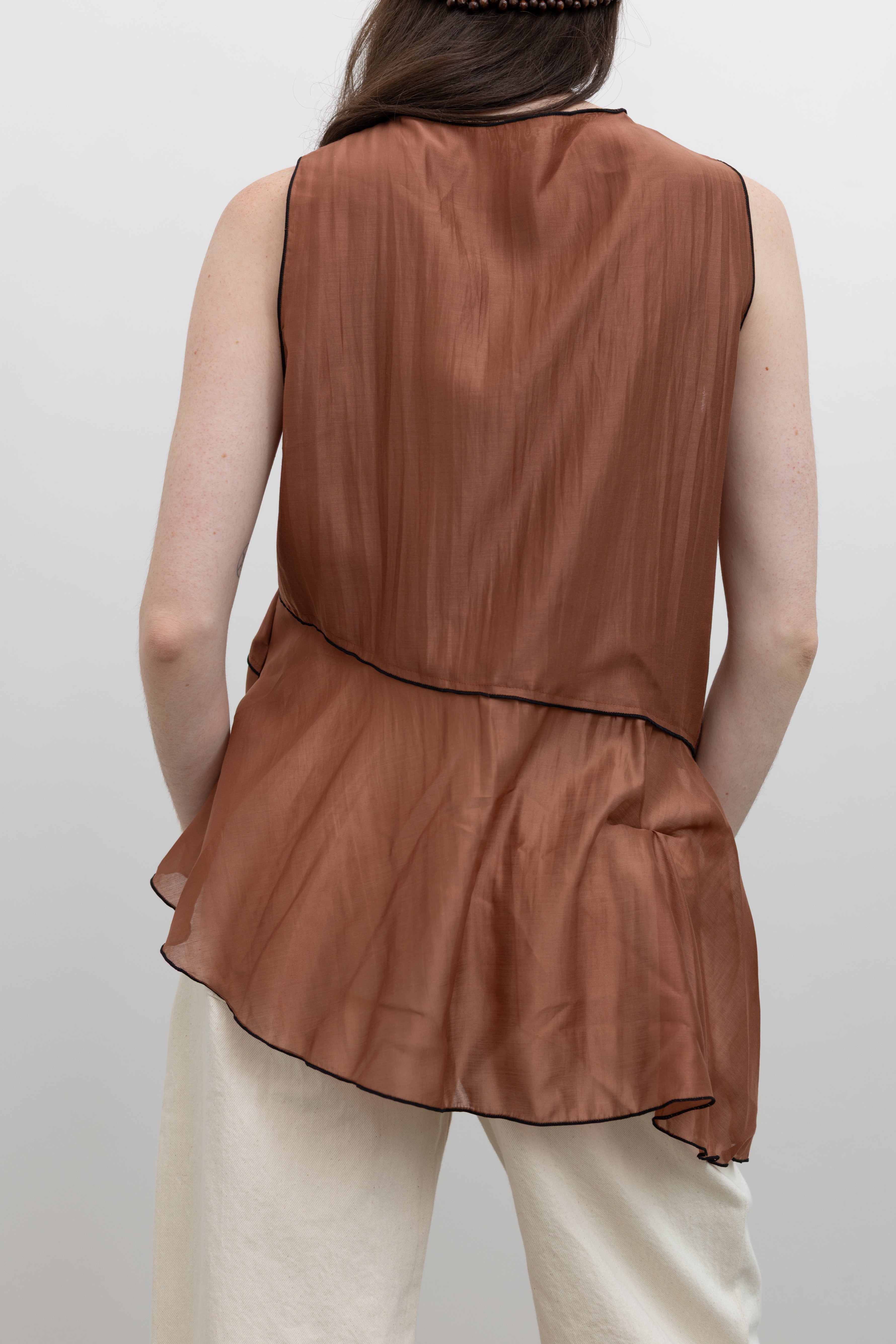 Collective sleeveless designer top showcasing relaxed elegance and contemporary women's ready-to-wear fashion at Alas Eius