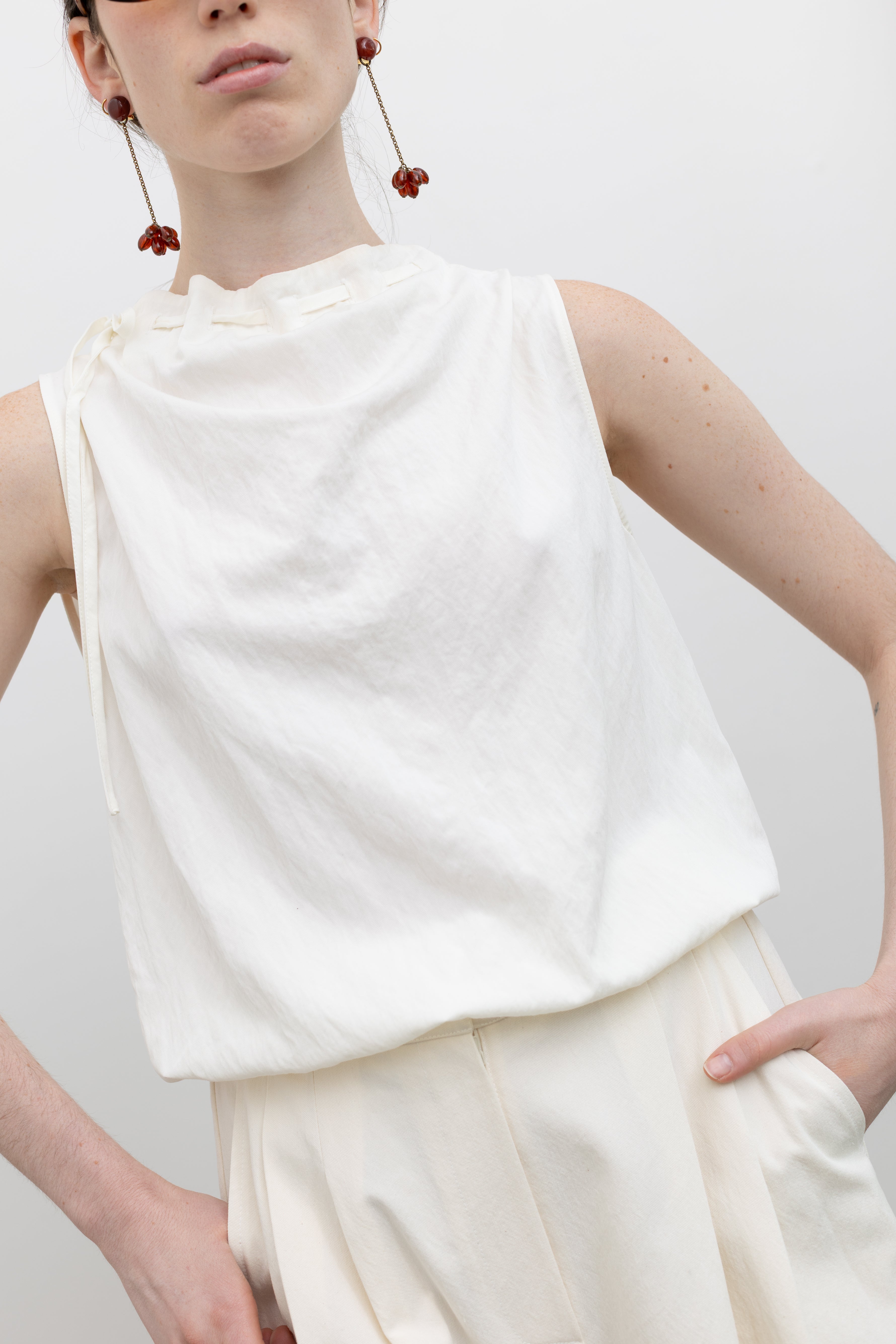 Collective sleeveless rayon blend top with sculptural mock neck and bubble hem, styled for modern women's minimalist fashion at Alas Eius