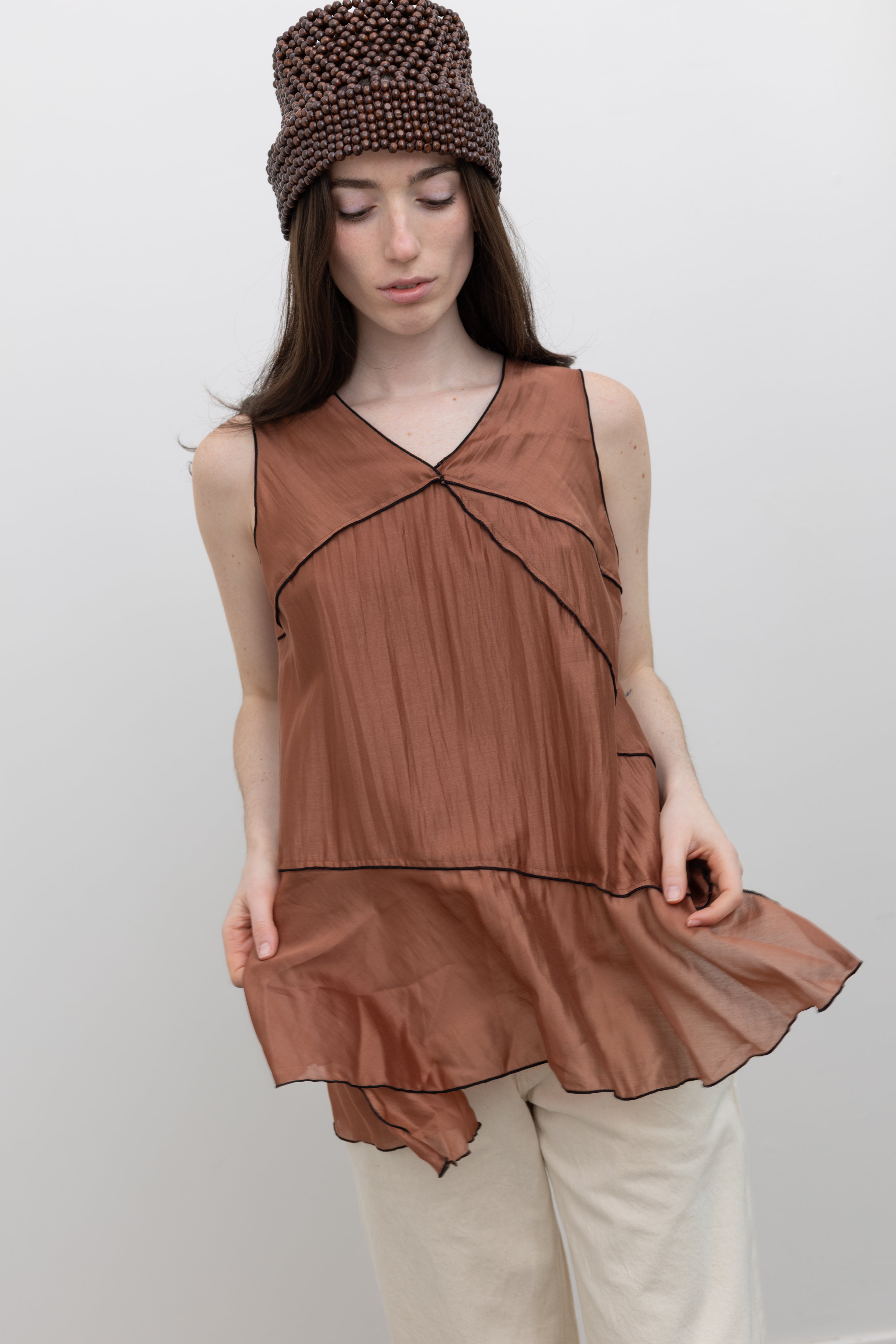 Collective sleeveless Tencel top with a flowing silhouette and V-neckline, styled for modern women's contemporary fashion at Alas Eius