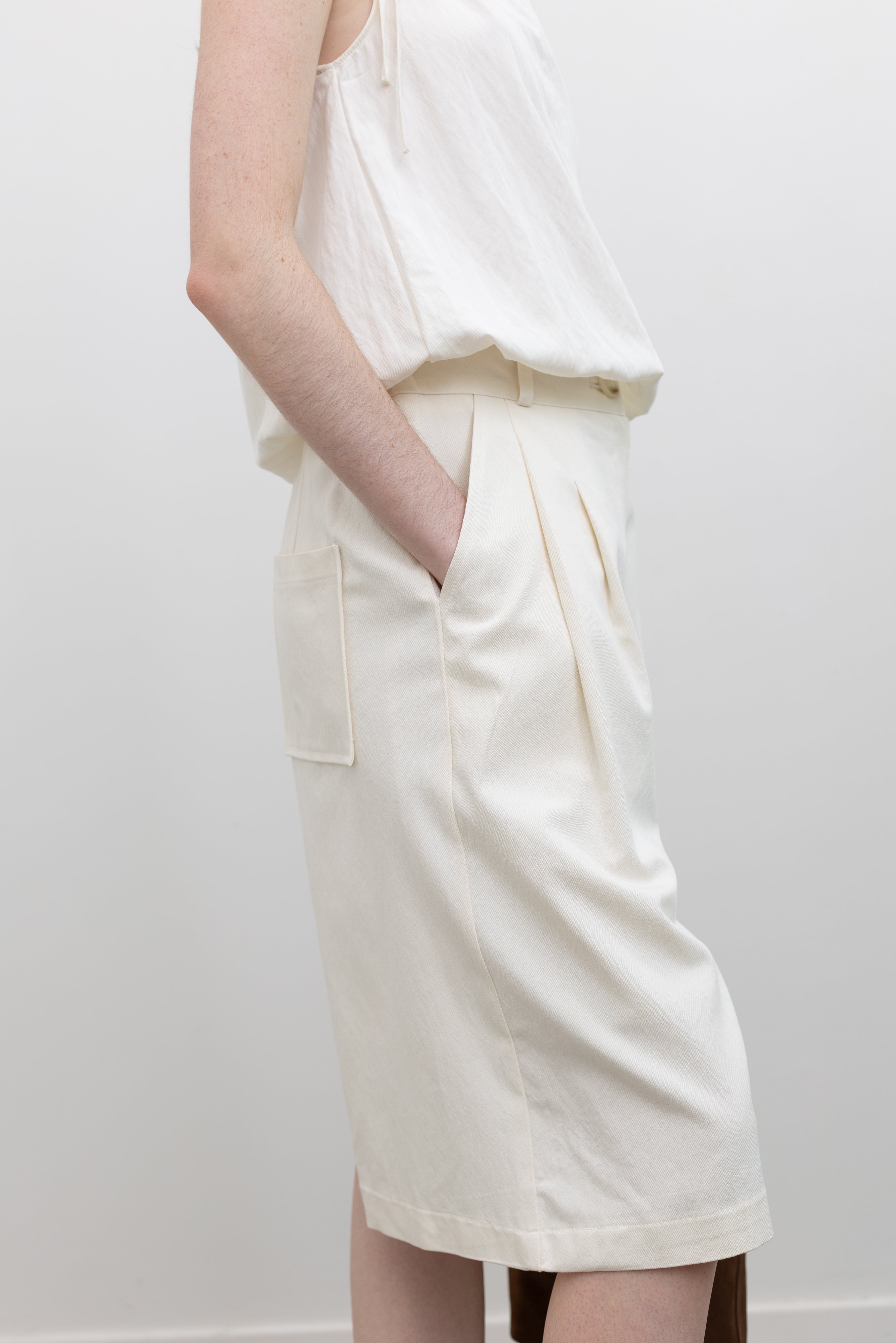Collective tailored bermuda shorts featuring pleated front detailing and relaxed women's capsule wardrobe essentials at Alas Eius
