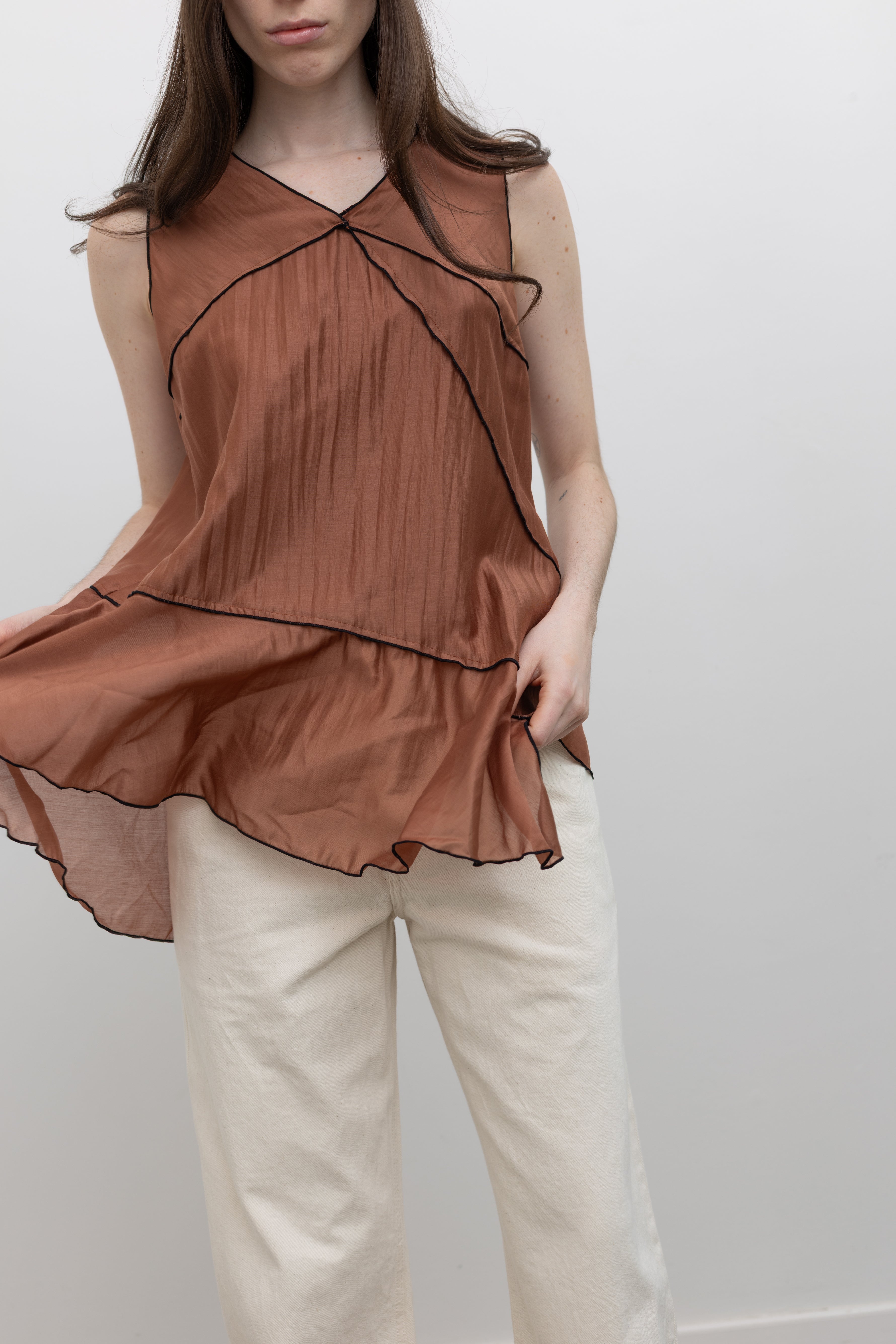Collective V-neck Tencel top with tiered asymmetrical detailing, perfect for women's capsule wardrobe essentials at Alas Eius