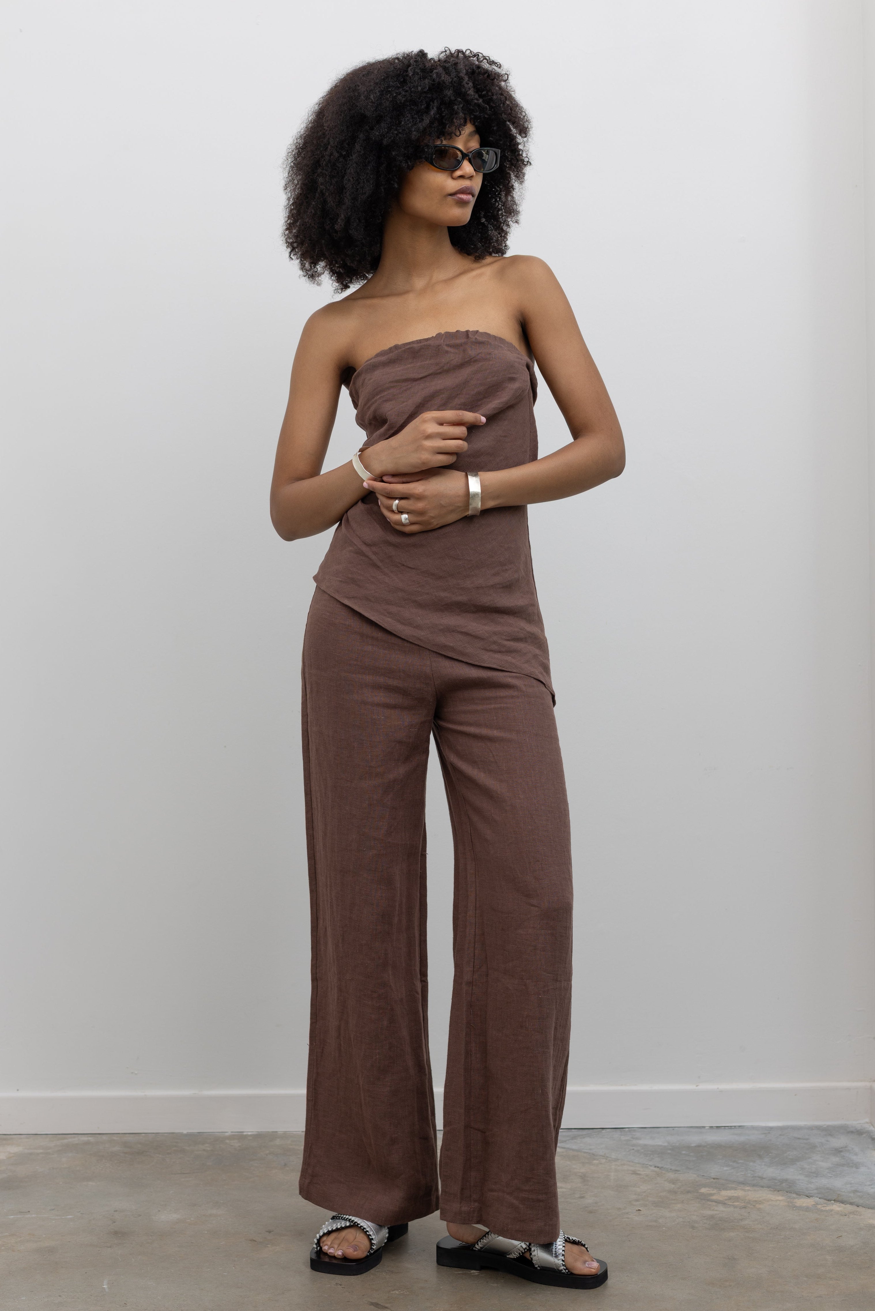 Collective wide-leg linen pants with fluid drape and mid-rise waistband at Alas Eius