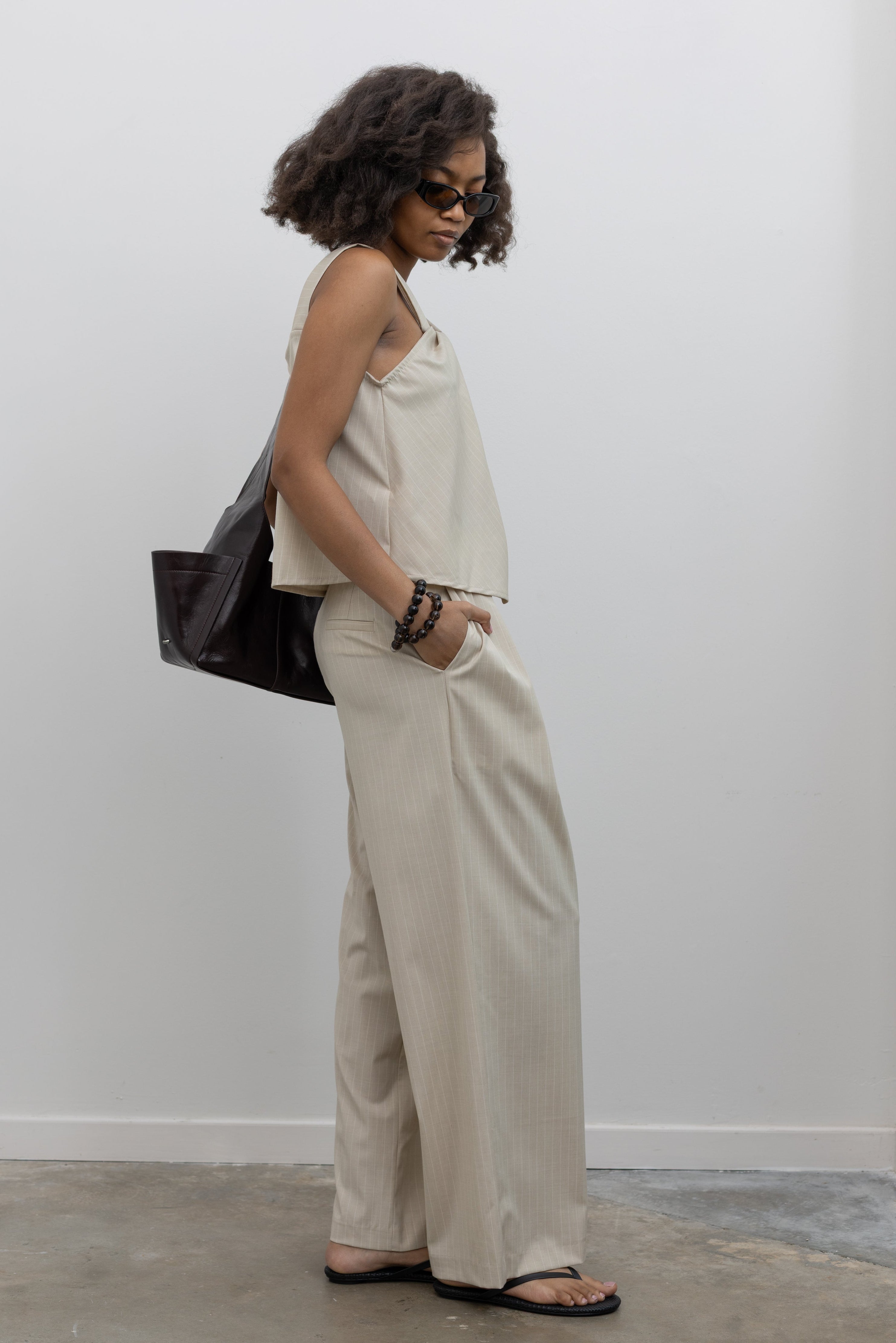 Collective wide-leg pinstripe pants with tailored pleats at Alas Eius
